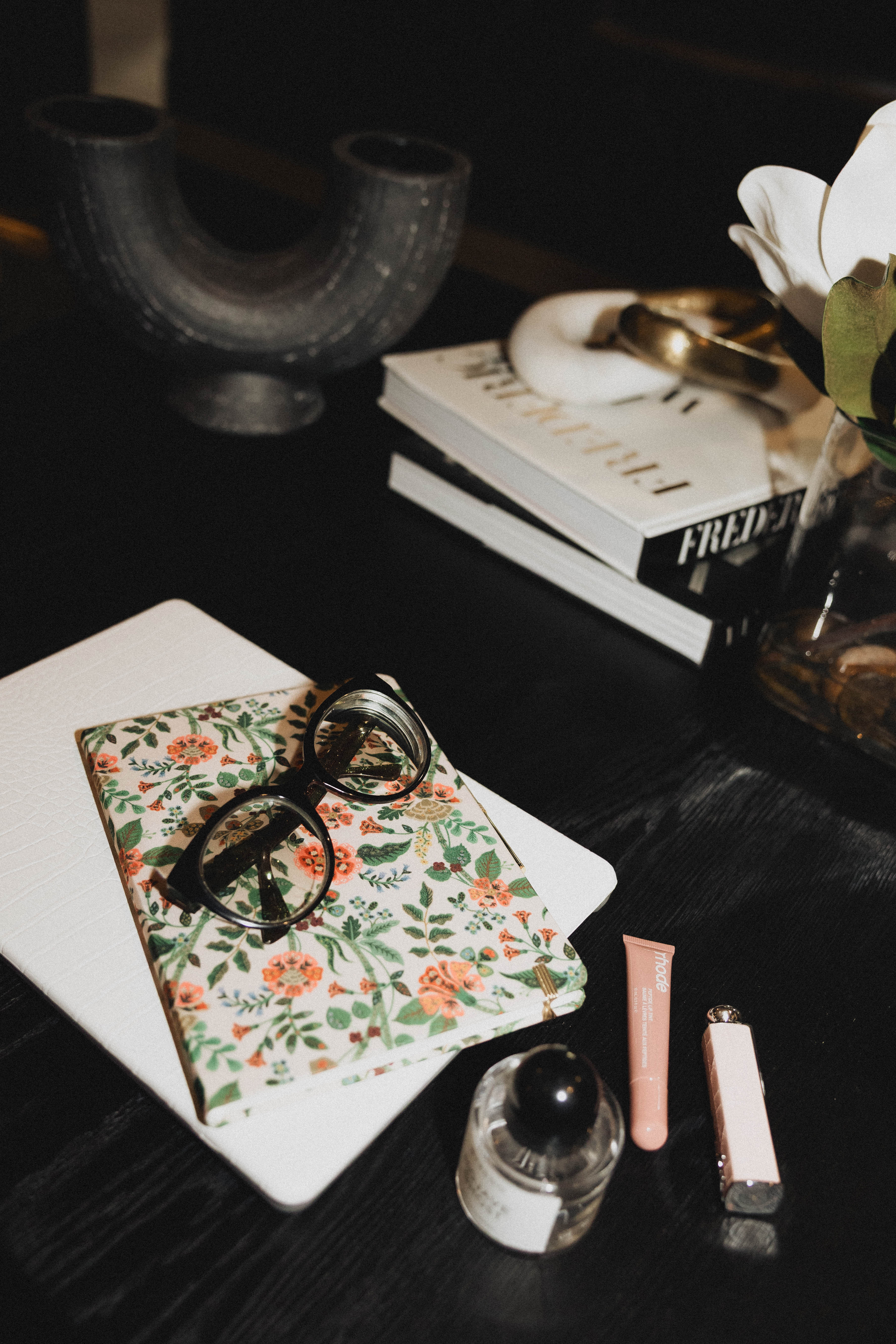 My work grind faves featuring all my daily must-haves that keep me focused and feeling put together. From my MacBook with a chic laptop case and Rifle Paper Company planner for staying organized, to my blue light glasses for long screen days, these are the essentials that carry my workflow. I never skip rhode lip gloss, Dior Addict Lip Balm, or a spritz of Byredo perfume because productivity looks better when you feel polished. Perfect for work-from-home routines, office desk aesthetics, productivity must-haves, and luxury everyday essentials.

#LTKHome #LTKFindsUnder50 #LTKdayinmylife