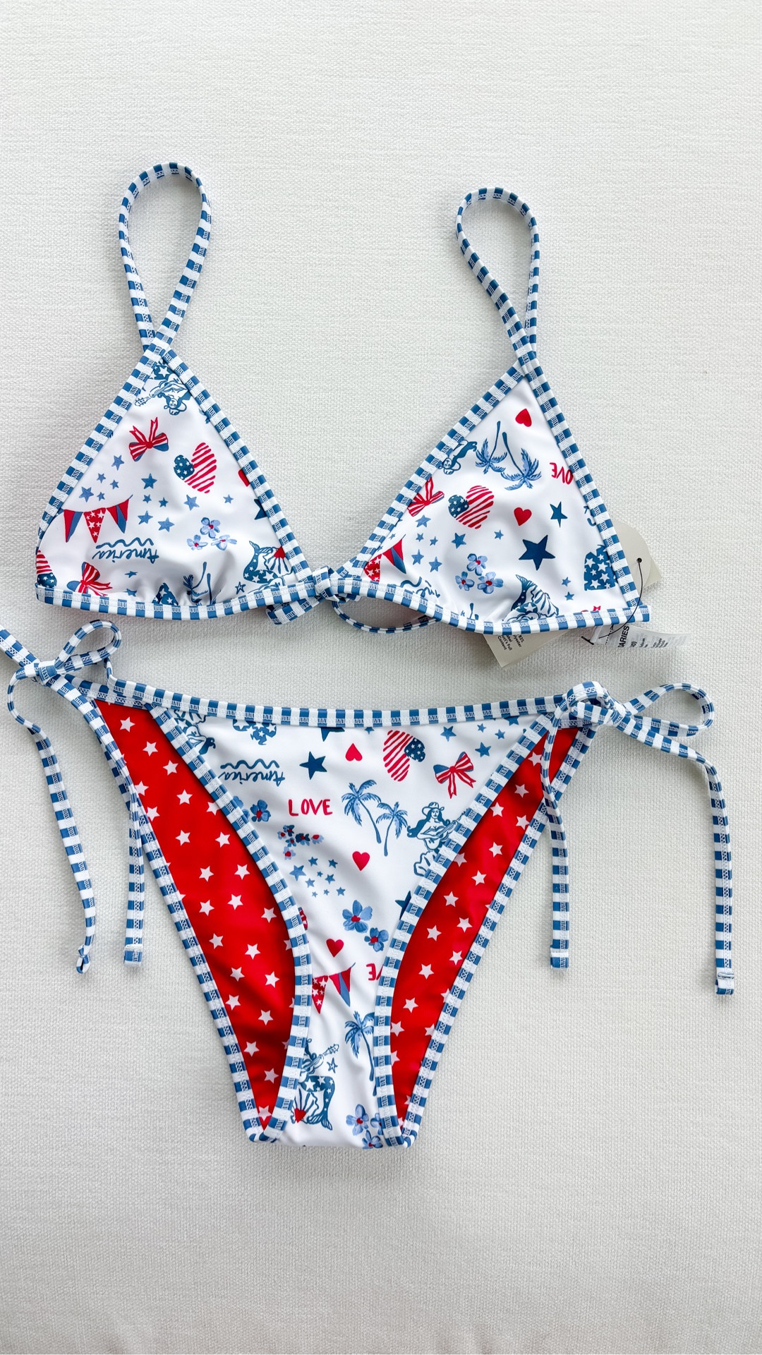Obsessed with this!!! Got a M in both the top and bottom (I used another Walmart bikini for reference and it fits perfectly)! So perfect for Americana summer and the 4th!!! 

American summer
Americana summer
Patriotic swimsuits 
2026 swimsuits 
Cute cheap swimsuit 
Cute cheap bikini 
Cute swimsuit 
Cute bikini 
Roller rabbit
Roller rabbit dupe 
Stoney clover 
Stoney clover dupe 
Preppy 
Red white and blue 
Walmart find
Americana bikini
American flag bikini
Fourth of July bikini
4th of July swimsuit
Patriotic swimwear
USA bikini
Red white and blue bikini
Memorial Day swimsuit
Labor Day swimwear 
Summer patriotic outfit
Coquette bikini
Coastal coquette swimwear
Girly bikini
Cute string bikini
Triangle bikini
Tie side bikini
Vintage Americana
All American girl aesthetic
Cottagecore summer swim
Feminine swimwear
Beach vacation bikini
Summer beach outfit
Pool day bikini
Lake day swimsuit
Boat day outfit
Resort swimwear
Tropical vacation bikini
Beach club outfit
Coastal granddaughter style
Hamptons summer style
Blue and white bikini
Red white blue swimsuit
Star print bikini
Heart print bikini
Gingham trim bikini 
Printed triangle bikini
Cute patriotic print
Preppy swimwear
Americana print swimsuit
Novelty print bikini
Summer 2026 swimwear
Viral bikini
LTK summer finds 
Vacation must haves
Amazon bikini dupe
Designer inspired swimwear
Beach essentials
Summer outfit inspiration
Trending swimwear
Coastal summer style
Cute red white and blue bikini
Patriotic bikini for Fourth of July
Coquette Americana swimsuit
Preppy patriotic swimwear
String bikini with tie sides
Coastal cowgirl beach outfit
Hamptons inspired swimwear
Old money beach aesthetic
Americana beach girl style
Fourth of July pool party outfit

#LTKSwim #LTKMidsize #LTKPetite