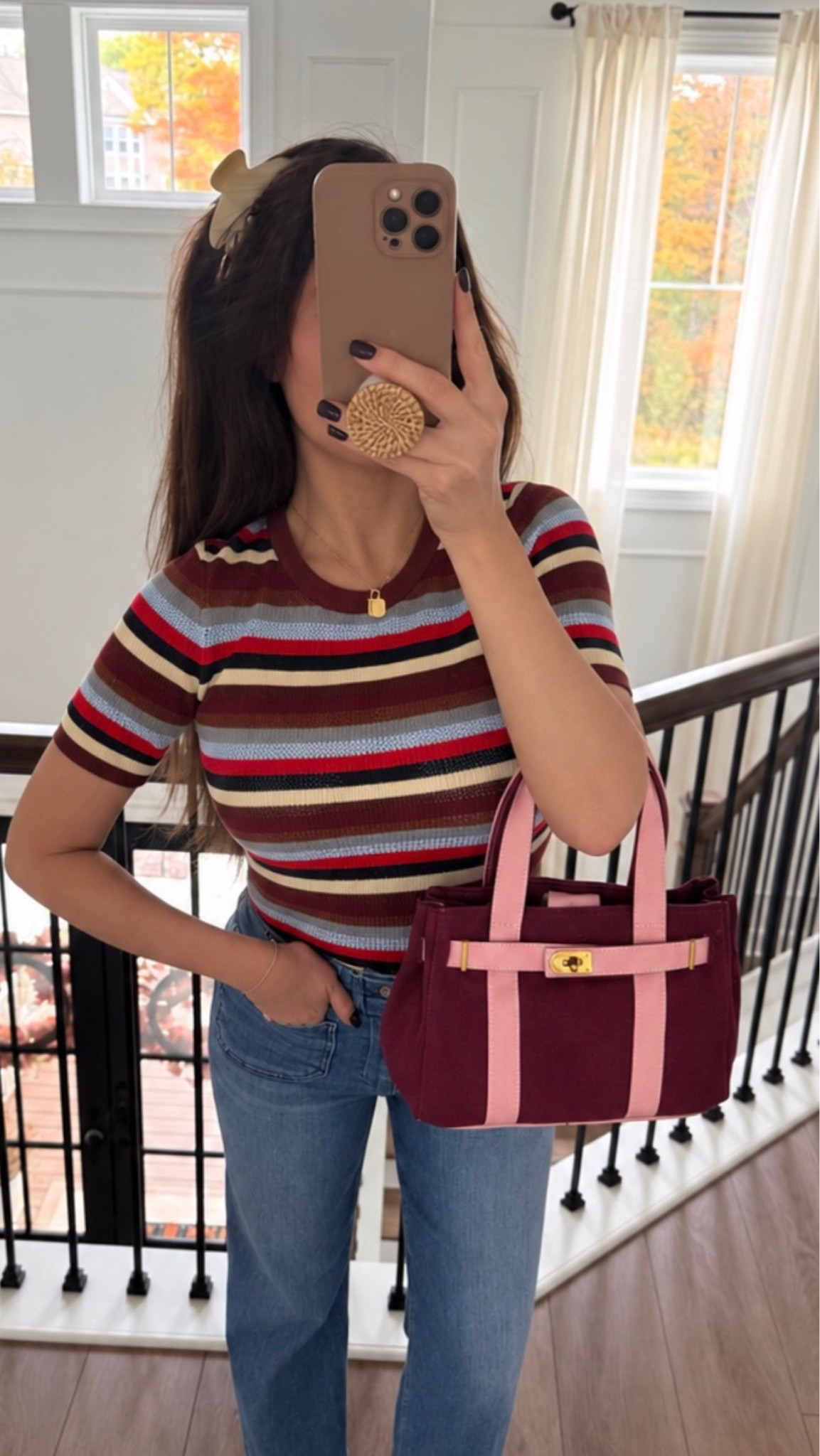 This top is so flattering and on sale. Wearing a Small. It’s form fitting and the bag is brand new!