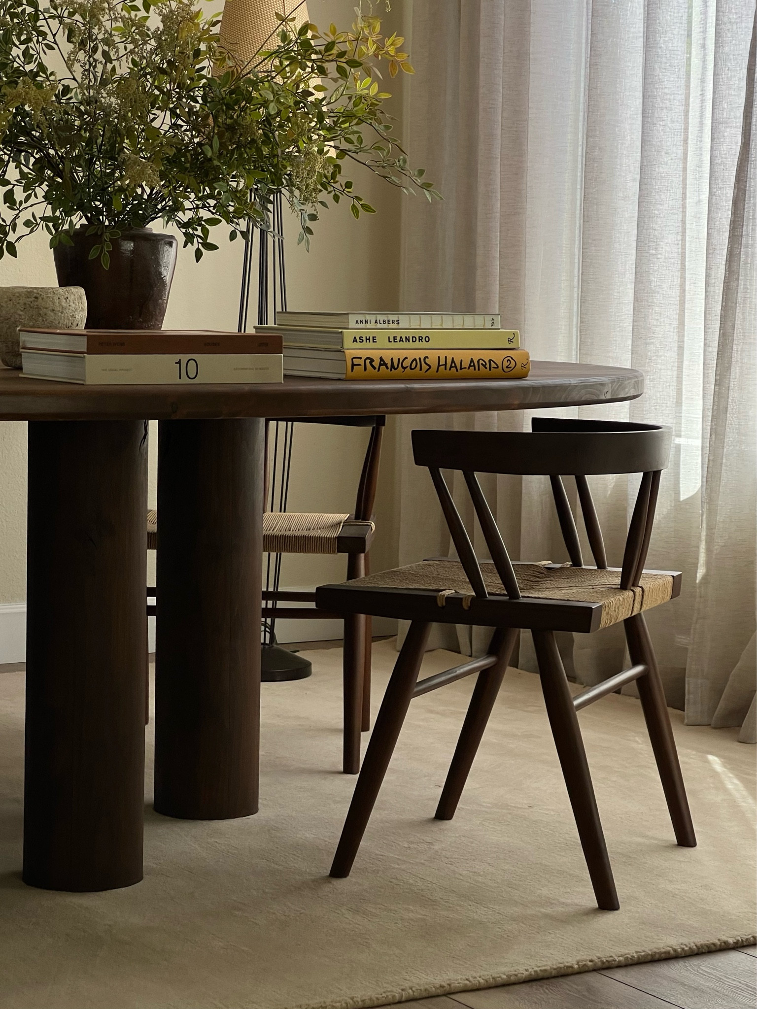 dining room rug + chair. linked a more affordable version of my dining chair from wayfair also 🤎