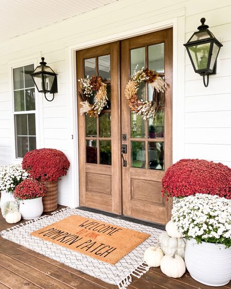 Front porch and door decor fall autumn harvest seasonal entry French double doors oversized layered scatter rug and doormat pumpkin magnolia trees faux artificial silk florals mums baskets wreaths outdoor lanterns wall sconces rocking chairs light fixtures southern modern farmhouse style home decor nearly natural amazon finds Etsy wayfair marshalls TJ Maxx home goods Walmart autumn oak trees 

#LTKSeasonal #LTKhome #LTKHalloween