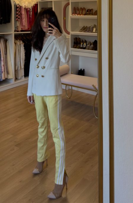 Spring has sprung and the office is calling! This look takes workwear to a whole new level, offering both comfort and style. Obsessed with this fitted white double-breasted blazer – it's the perfect layering piece for those in-between weather days. Paired with trendy butter yellow tracksuit pants, it creates a surprisingly chic and unexpected combo. Don't be fooled by the comfy vibes – the heels instantly elevate the look, making it perfect for the office. This outfit is all about playing with textures and proportions, and is sure to turn heads in the best way possible. Spring work outfits for women don't have to be boring – try this combo for your next meeting and see for yourself! #springworkoutfit #springofficeoutfitswomen #outfitideasspring #LTKspring #LTKsale #workoutfit #trackpants

#LTKworkwear