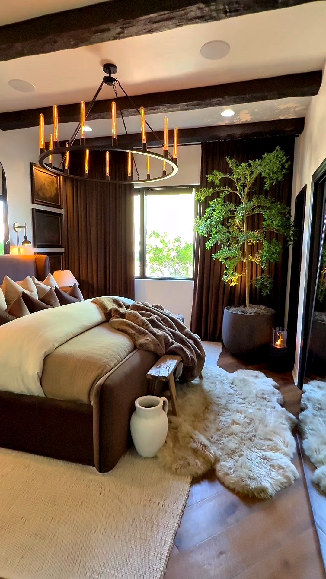 Love the warmth and life this faux plant brings to the room! 

Faux greenery. Faux tree. Moody home decor. Neutral bedding. Chocolate bedding. Home decor inspiration. Faux fur accent rug. Bench. Modern home. Wagon wheel chandelier. Matching nightstands  

#LTKHome #LTKFindsUnder100 #LTKSeasonal