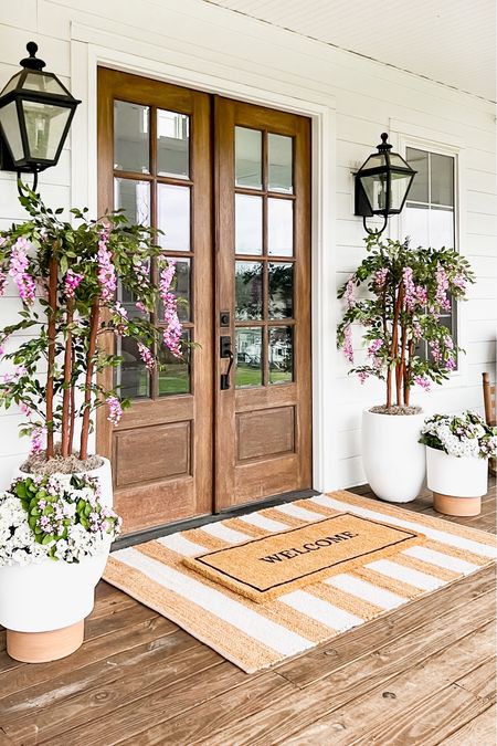 Spring Front Porch!! Loving these wisteria trees! Use BRUNOANDLIBBY for 30% off at nearly natural! Jute rug is 4x6. Front porch and front door decor large white planter trending viral home decor pottery barn dupe look a like look for less artificial faux plants trees flowers florals greenery modern farmhouse southern porch lantern, outdoor light fixtures, wall sconces lighting silk faux flowers d geraniums, hydrangeas kalanchoes pink florals jute rug scatter rug welcome mat doormat, double layered

#LTKstyletip #LTKhome #LTKsalealert