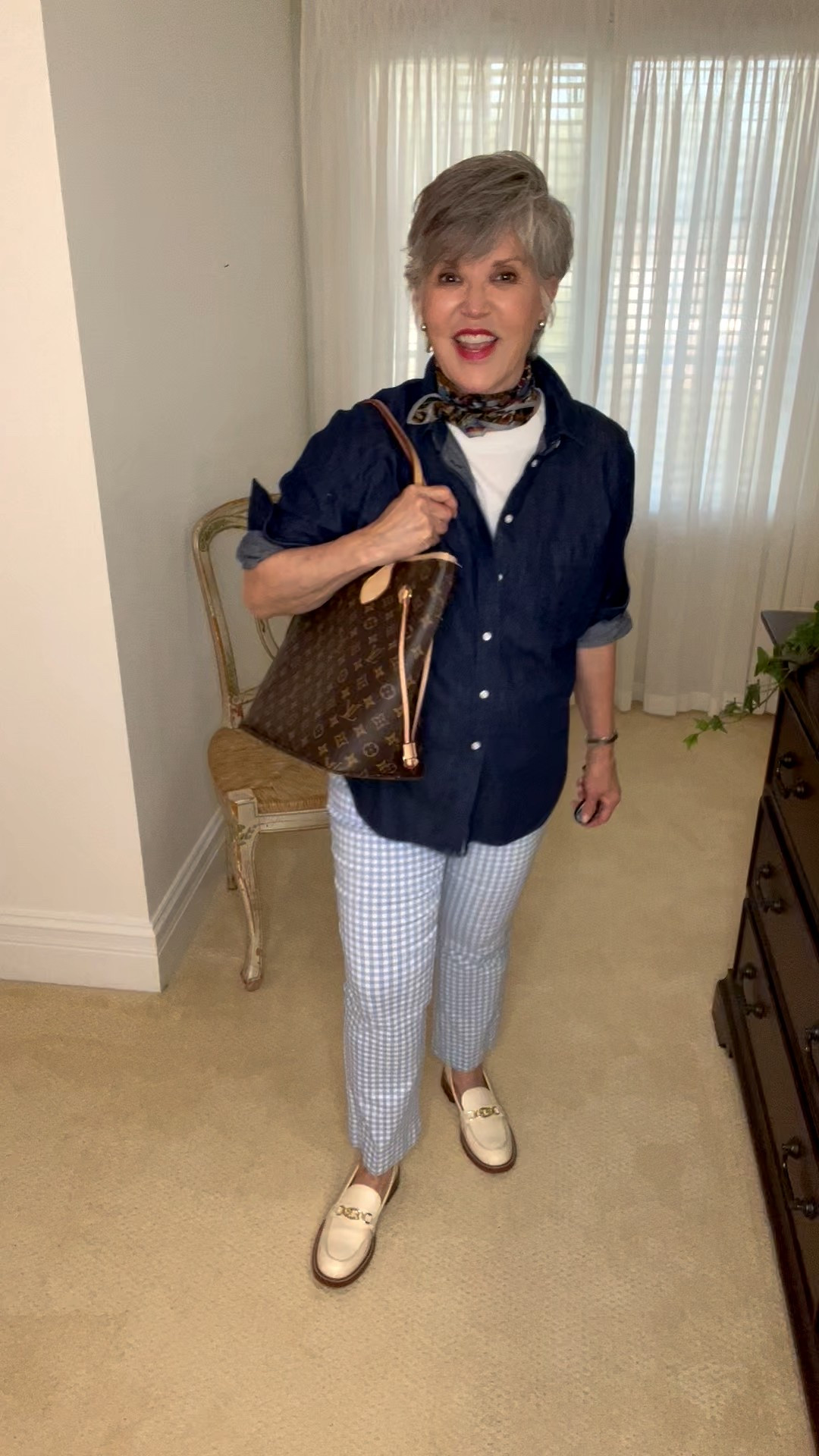 Gingham pants paired with denim, a silk scarf, and loafers for a polished French-inspired look. 
Classic gingham pants with a white crew neck tee (such as buy!) layered under a dark denim shirt, sleeves rolled and buttoned up. Finish with a knotted blue print scarf, cream leather bit loafers, and a Louis Vuitton tote. A chic outfit for fall errands, travel, or city days.

#LTKOver40 #LTKFindsUnder50 #LTKStyleTip