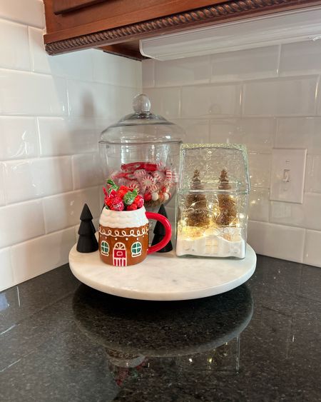 Easy Christmas kitchen decor idea. Snagged this clear gingerbread house at the bullseye playground and added salt+ string lights + mini Christmas trees! Also I love this candy jar +lid for switching out seasonal candy. 

#LTKHoliday #LTKGiftGuide #LTKhome