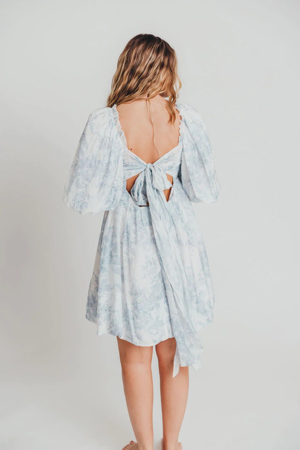 Melody Mini Dress with Pleats and Bow Detail in Baby Blue Floral | Worth Collective