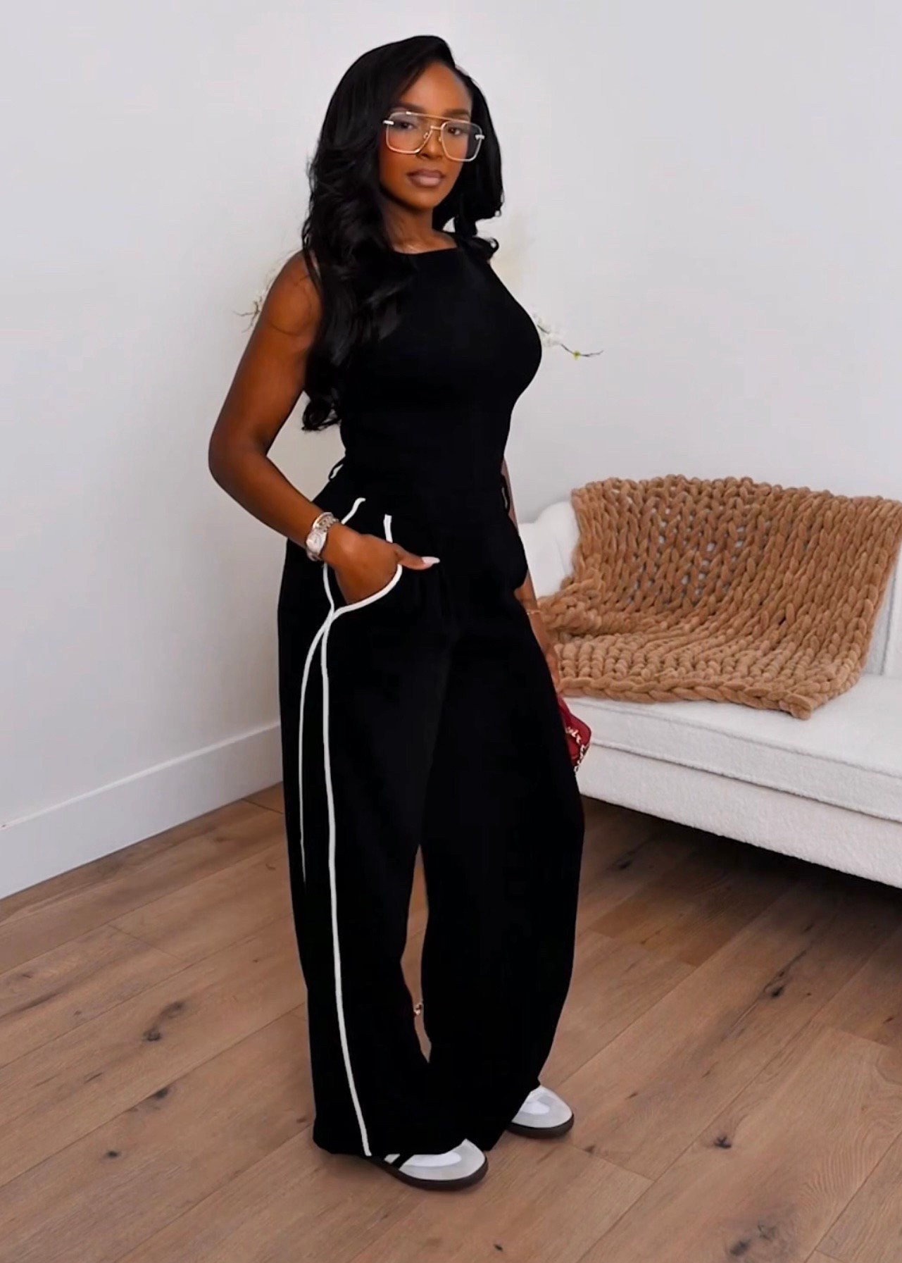 Sporty Chic Energy — This black sleeveless jumpsuit with contrast side stripe detailing is the definition of effortless cool. Relaxed wide leg fit, cinched waist, and sporty piping give it that off-duty model vibe while still looking put together. Styled casually here but easily dressed up with heels for a sleek street style moment.

Perfect for running errands, casual Fridays, travel days, coffee dates, and everyday elevated comfort.

📏 Sizing: Wearing size Small  
Height 5’4” | 138 lbs | Bust 34D | Waist 27” | Hips 40”

This versatile black jumpsuit is a true cost per wear staple — styled casually with flats or elevated with heels and a blazer. The more ways you wear it, the lower your cost per wear drops. A great long-term shopping strategy piece that transitions from sporty casual to elevated chic with simple swaps.

Black jumpsuit outfit, wide leg jumpsuit, sporty chic outfit, casual everyday outfit, travel outfit idea, athleisure style, comfortable jumpsuit for women, minimal capsule wardrobe staple, modern casual fashion, off duty model style.

Tap to get details and shop instantly on the app.

Follow me on Instagram and YouTube @kirasfashionfinds