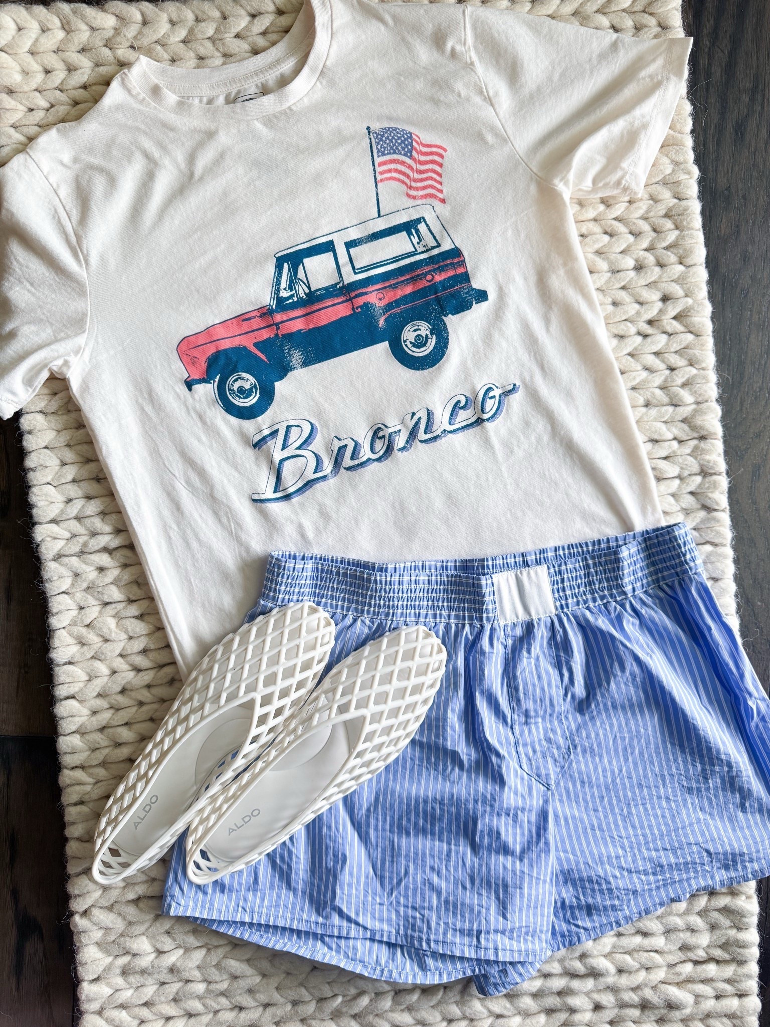 Patriotic but make it playful. I grabbed this boys XL Bronco graphic tee & it’s perfect for a relaxed women’s summer look—think 4th of July, lake weekends, or casual BBQ nights. Styled with boxer-style shorts & my favorite jelly flats for that effortless, styled look that I always go back to. 

Tee XL boys
Shorts S
Sandals size down one whole size 

First shared May 16, 2025 #and321

bronco tee - tee shirt style – vintage inspired summer look – patriotic graphic tee – oversized tee summer outfit – casual fourth of july outfit – tomboy style women – jelly shoes trend – affordable summer outfit – kids section style hack – boxer shorts outfit – retro car tee women – summer outfit under 50

#LTKStyleTip #LTKSummerEdit #LTKShoeCrush