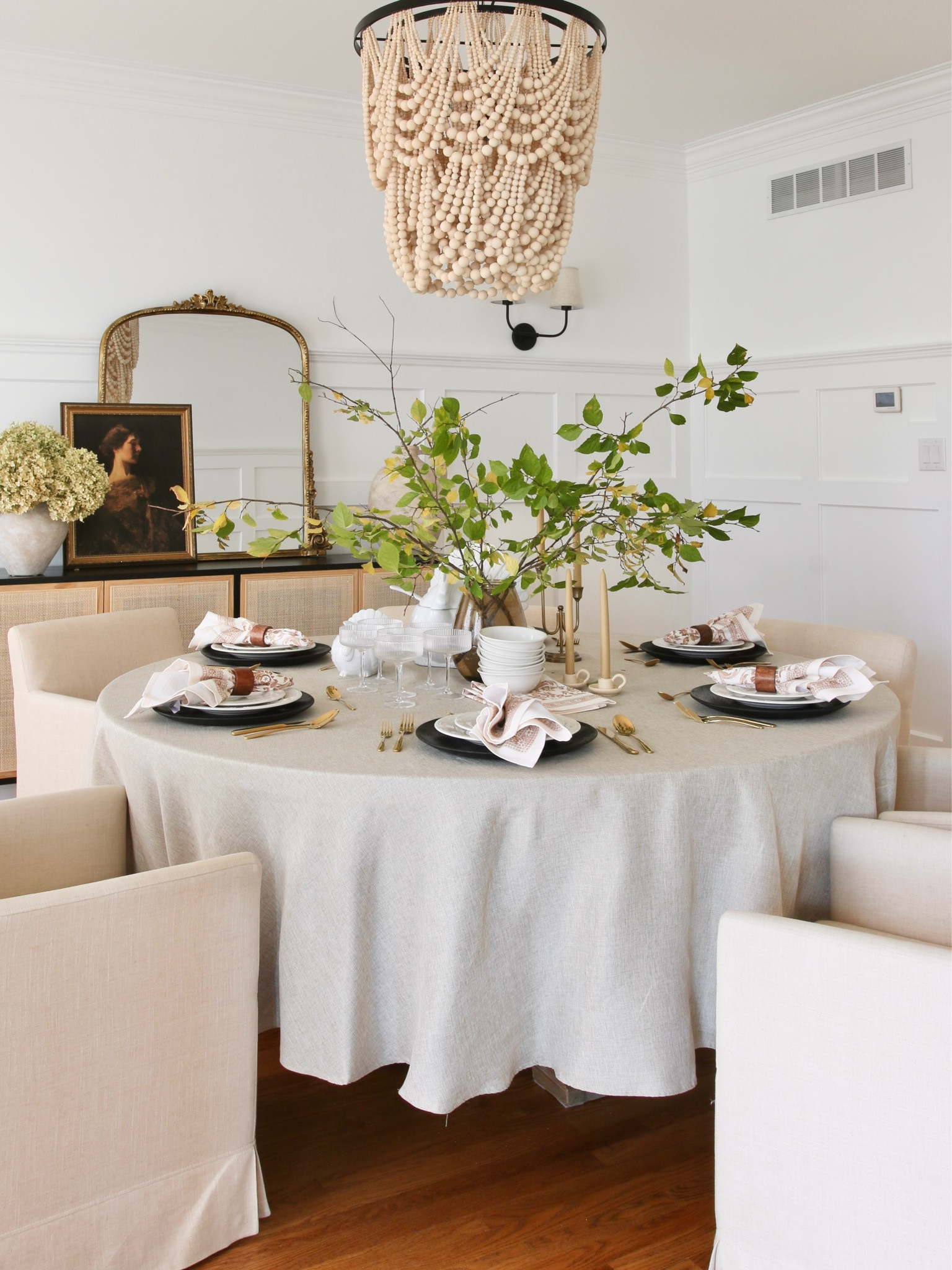 A view of my dining room during Thanksgiving. 
The dining table is set with a stoneware turkey tureen and gray boat from Pottery barn. The  linen tablecloth, cloth napkins and wood napkin rings are from Amazon. 
Surrounding the table are upholstered linen rolling dining armchairs from World Market, a wood bead chandelier from Pottery Barn and the Anthro Gleaming Primrose mirror

#LTKhome #LTKFind #LTKstyletip