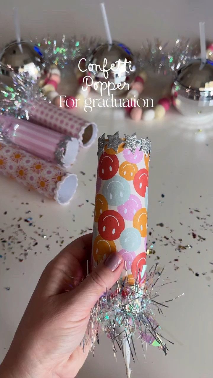 DIY graduation party poppers✨🎓🎓💜🩵🩷 I have to say these confetti poppers are too cute. My kids have a blast with these.

What you need
TP roll
Cute cardstock
Tape or hot glue
Balloons
Confetti
Tinsel garland or cute ribbon 

Tie and cut the balloon tip off, put it over the top roll, wrap your tube in the cardstock and then add ribbon. Add confetti, pull balloon back and let it ✨✨✨

Comment CONFETTI below to receive a DM with the link to this post 

#graduationparty #confetti #partyinspiration #graduationdecor #summerishere summertime graduation party ideas

#LTKmomlife #LTKSeasonal #LTKKids