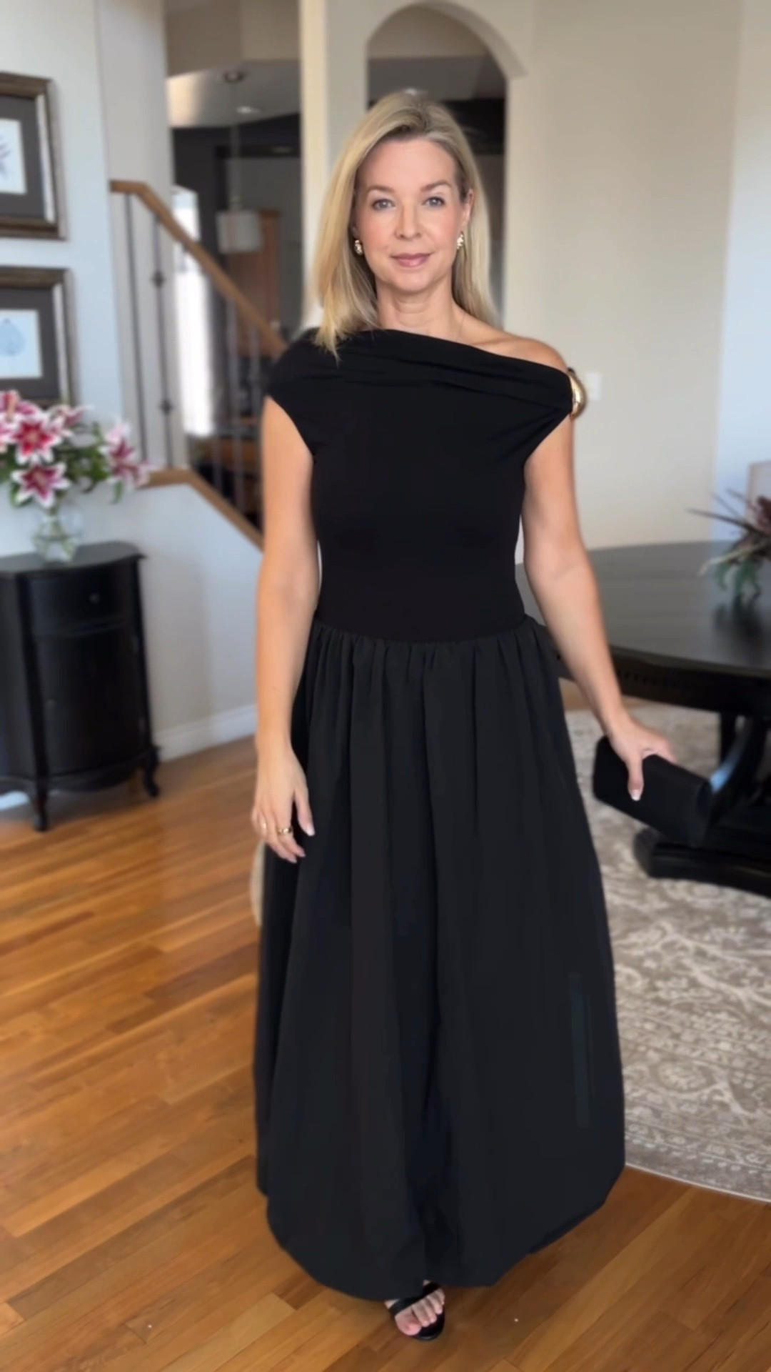 Stunning all black maxi length bubble hem dress
It’s fitted on the top and voluminous on the bottom. The fabric on the bottom reminds me of a taffeta type feel. 
It’s so pretty and elegant!
It has a removable gold clasp that dresses up the top. It can be worn as A one shoulder look or an off the shoulder look! 

#LTKHoliday #LTKStyleTip #LTKFindsUnder100