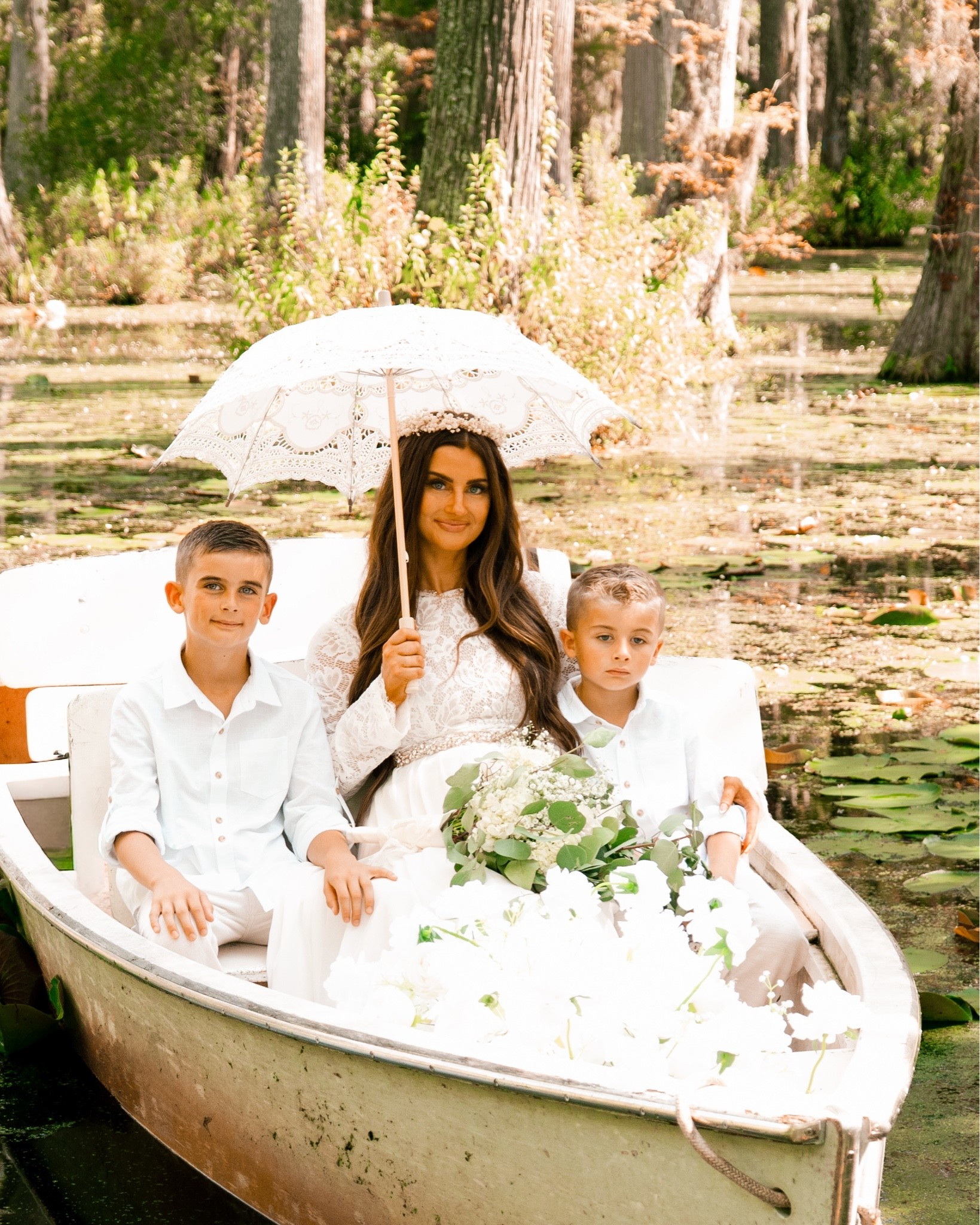 Wedding styled photo shoot
Lace umbrella 
Faux floral arrangement 
Lace wedding dress 
Boys linen button down top