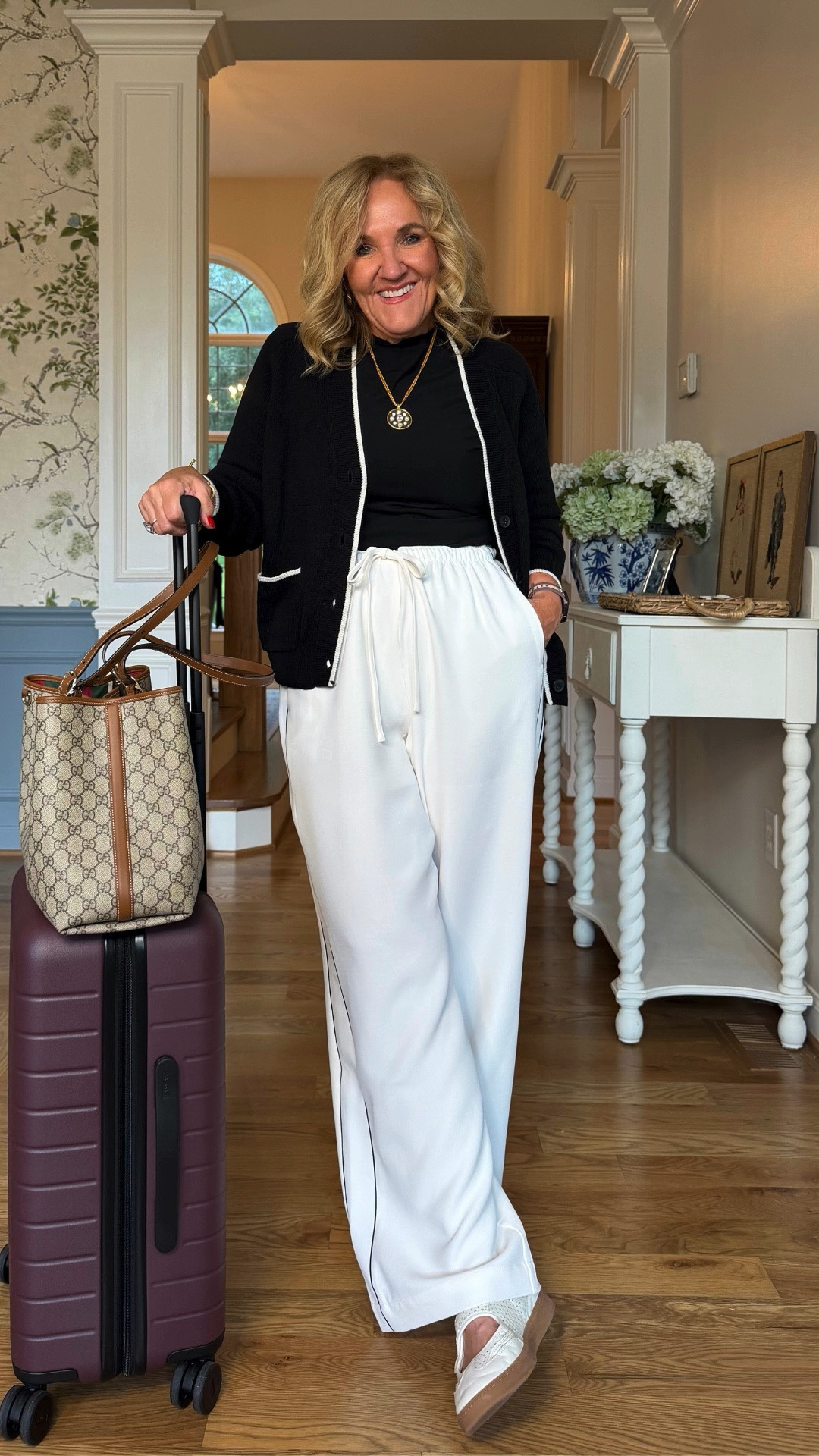 This black-and-white travel outfit is comfortable without looking too casual. A classic black cardigan with relaxed white wide-leg pants makes an easy airport-to-dinner look, and the woven sandals add a polished touch.

💡 LTK MADE EASY
❤️ Heart = Support my posts!
🔖 Save = Get sale & restock alerts
📋 Lists = Keep favorites organized
📲 Share = Send lists and products to a friend. Hello, Christmas List!
💬 Comment = Ask me anything about what I'm wearing.:-)

#LTKootd #LTKTravel #LTKOver40