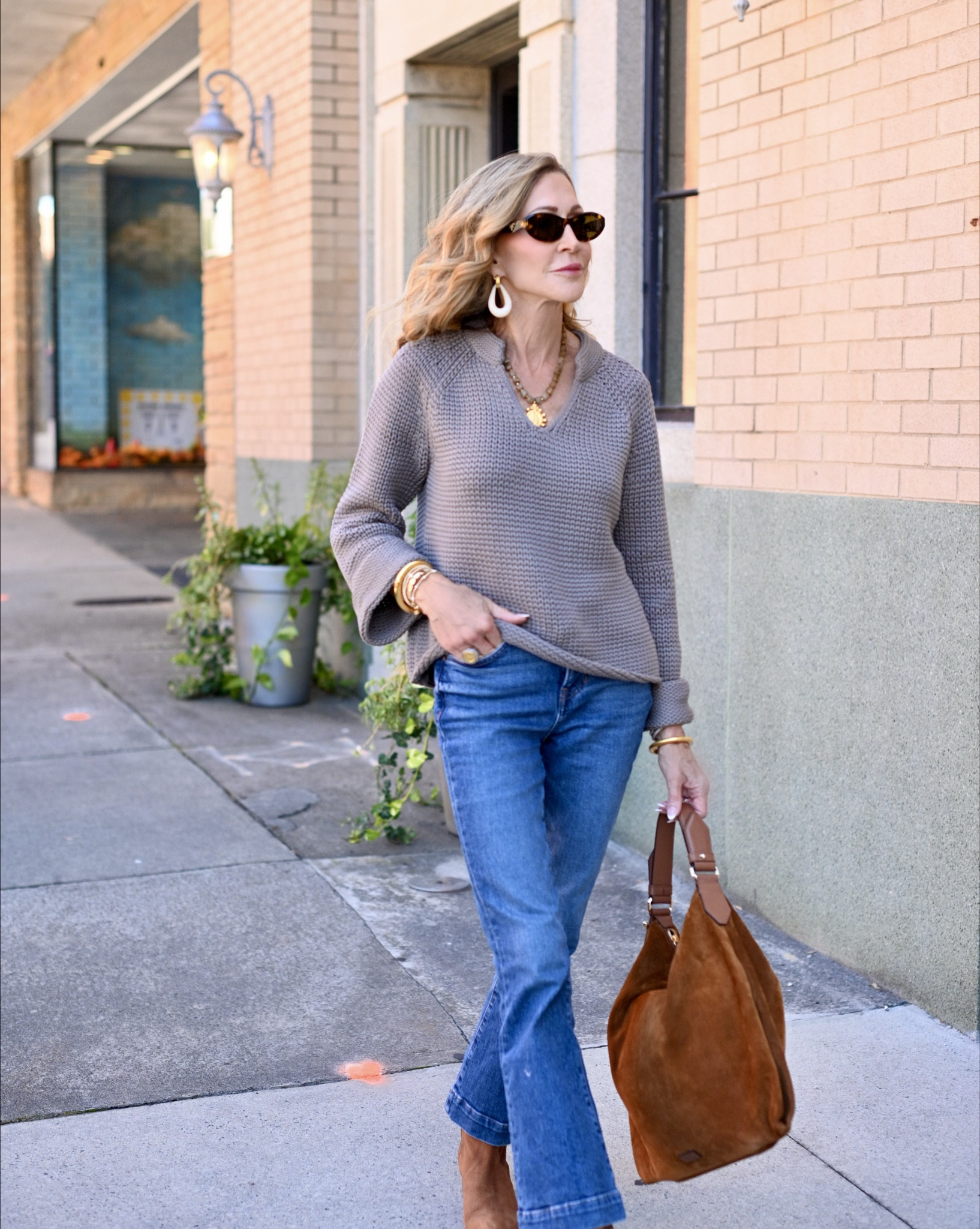 Wearing a chic casual outfit featuring a cotton sweater with bell sleeves and a v-neck.  This is a sweater you’ll wear on repeat!  It looks great with jeans but it’s also perfect with trousers or a skirt!  The jeans are cropped from Veronica Beard, boots are from M. Gemi, bag is suede from Jimmy Choo and I’m wearing Prada subglssses and Julie Vos jewelry!


#LTKStyleTip #LTKShoeCrush #LTKSeasonal