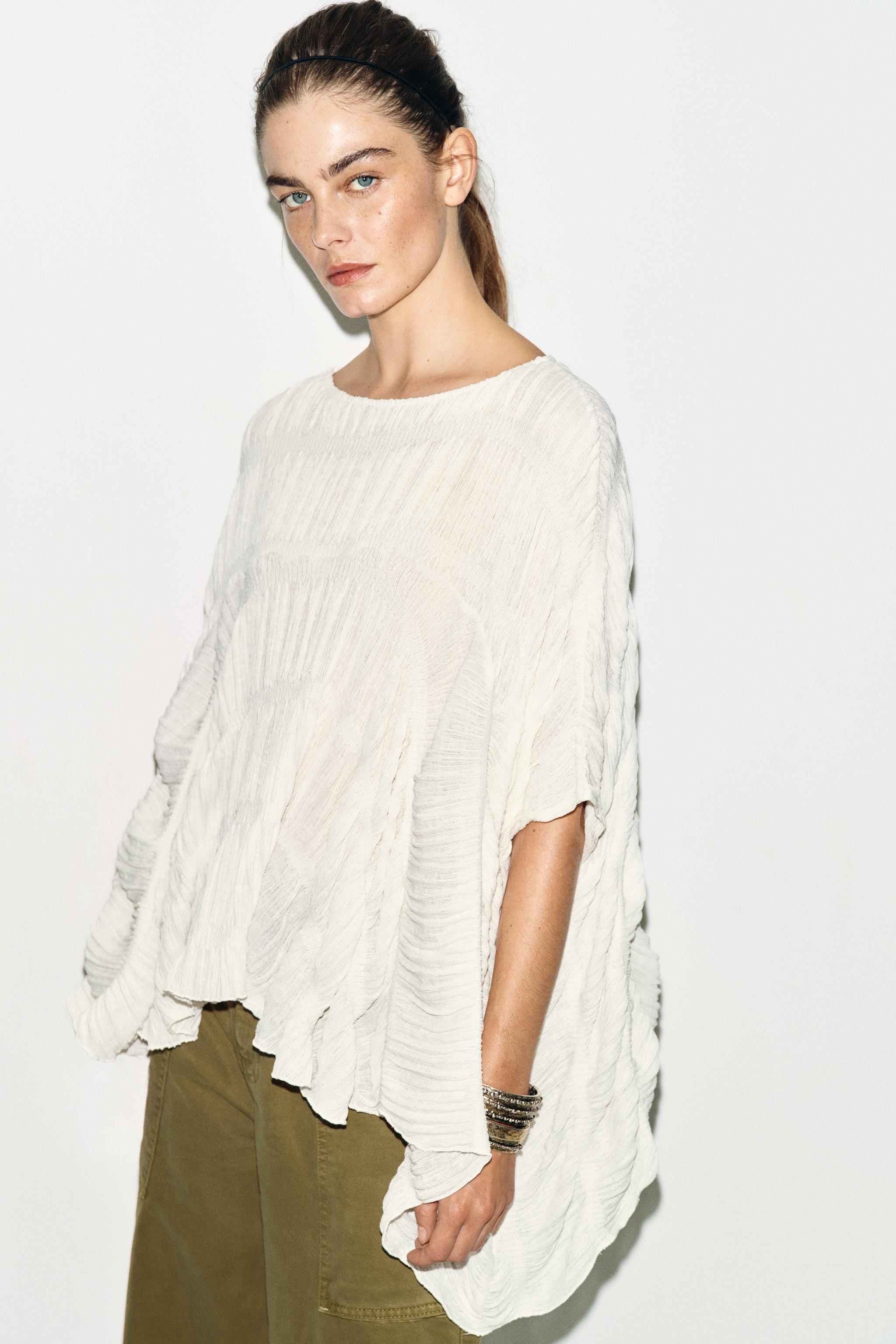 Round neck top with cape-style sleeves. Features textured fabric and ruching. Asymmetric hem. | Zara US