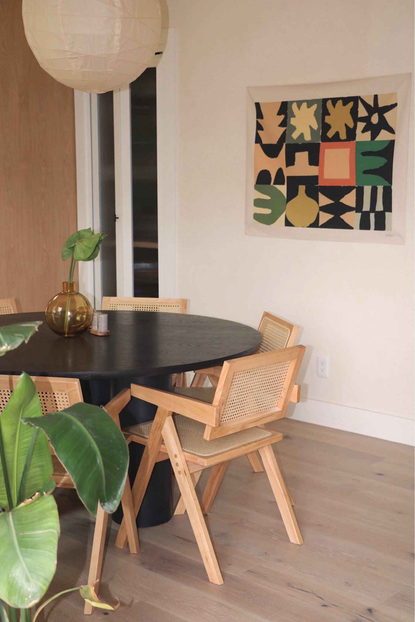 Dining room inspo ✨ featuring a warm paper rice pendant and black wooded table that compliments the warm natural chairs. Add a pop of color with this canvas painting! 

#diningroominspo #diningroomvibes #diningaesthetic #diningfurniture #homedesign 

#LTKhome