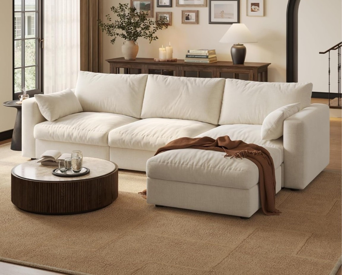Beige cloud sectional with that soft, cozy, elevated living room feel that instantly makes a space look warmer and more inviting. 🌿 Perfect for a family room, apartment, open living room, movie night setup, or cozy lounge space when you want deep seating, a chaise, and extra storage without sacrificing style. The oversized modular shape, chenille fabric, and storage ottoman make it practical for everyday lounging while still giving that plush designer look. 

Add this sectional if your living room needs a comfortable centerpiece that feels soft, roomy, and beautifully put together. ✨

#LTKSeasonal #LTKHome #LTKOver40