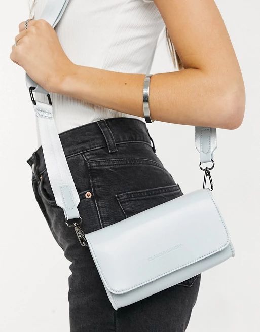Claudia Canova small cross body bag with webbing strap in pale blue | ASOS (Global)