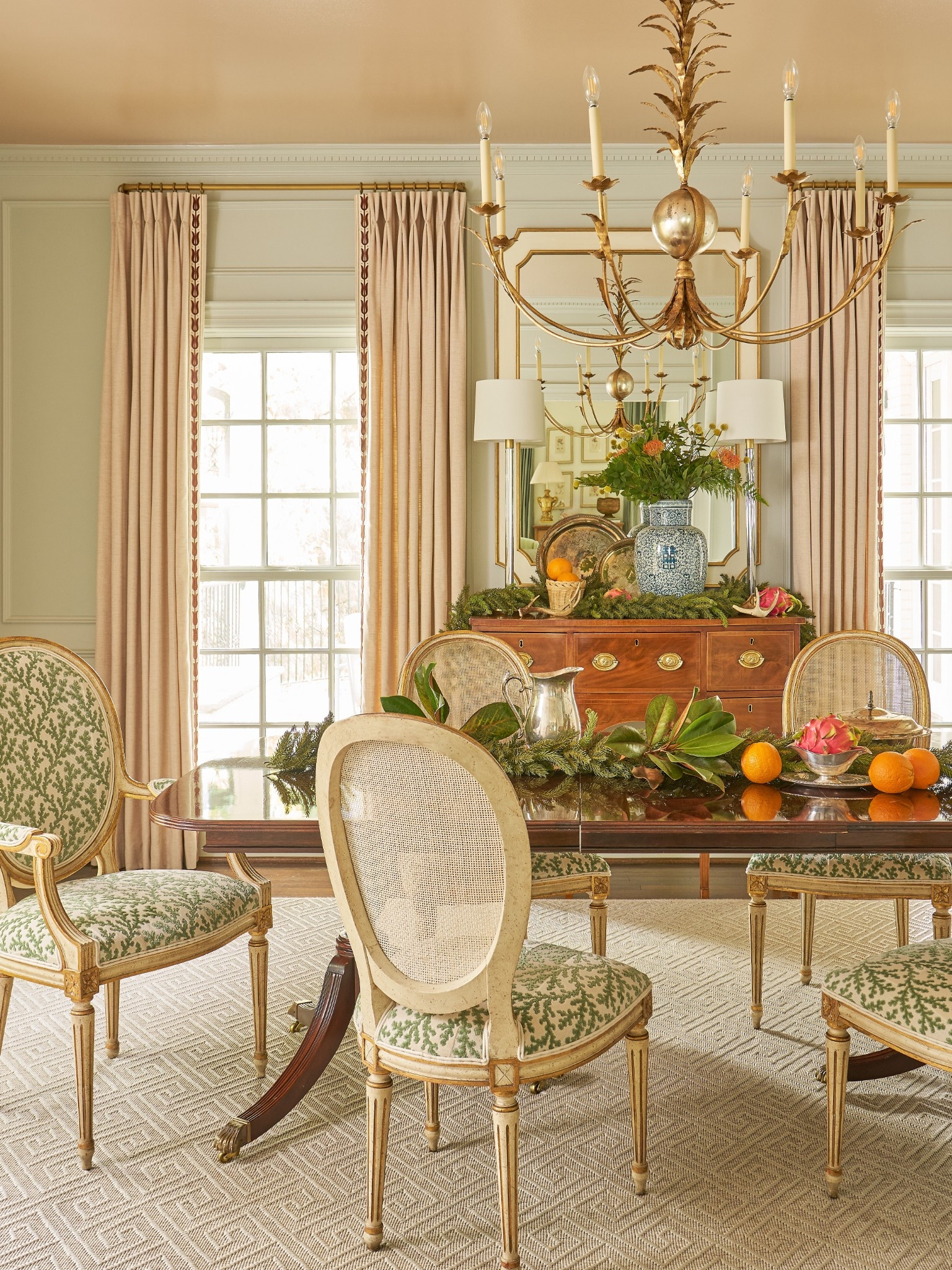 Decorating the Christmas table with faux garland, magnolia leaves cut from the yard, dragon fruit, oranges, silver and flameless candles 

#LTKHome #LTKHoliday