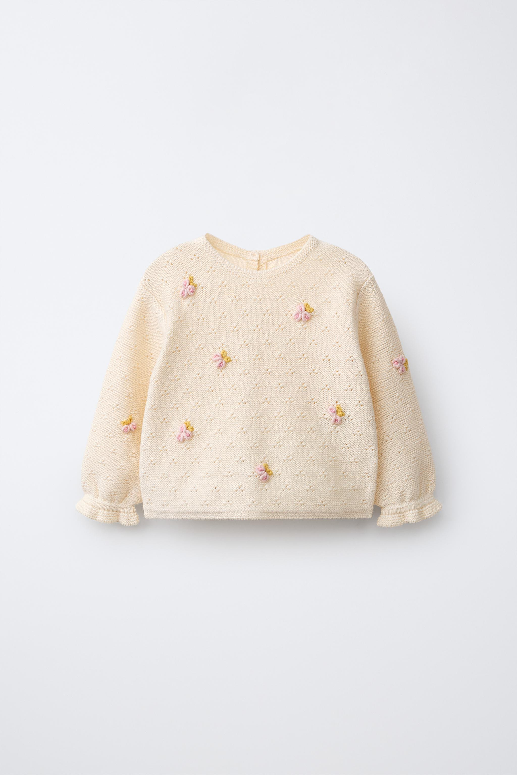 Jumper with round neck and long sleeves with elastic cuffs. Button closure at back. Openwork and ... | Zara US