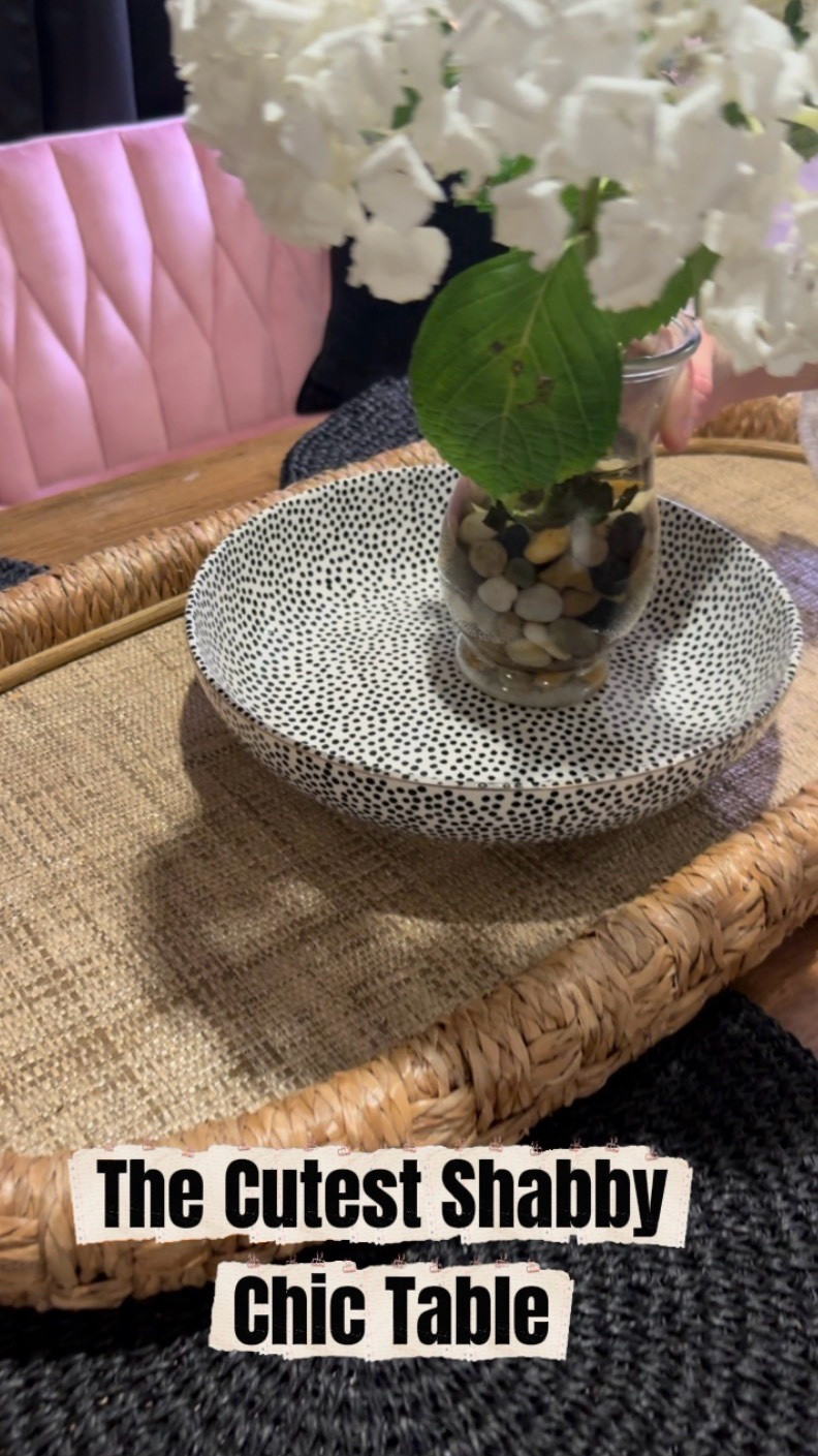 Watching my daughter set this table made my heart happy. 🤍 She has such a beautiful eye for mixing textures and patterns.

The warm wood table and black round placemats keep it grounded, while the animal print wall and black curtains add bold contrast. Then she softened everything with the sweetest centerpiece — a cream bowl with black polka dots inside a woven basket, hydrangeas in a clear vase with rocks, and artwork that pulls together the pink and black tones in the room.

It’s the perfect blend of shabby chic, feminine charm, and modern style.
Simple pieces styled with intention always create the most inviting table.

I could sit here all night visiting with family and friends. 🌸

⸻

Hashtags

#LTKhome #ShabbyChicDecor #DiningRoomStyle #TableDecorIdeas #HydrangeaDecor #LTKStyle #HomeStyling #PrettyHome #EntertainingAtHome