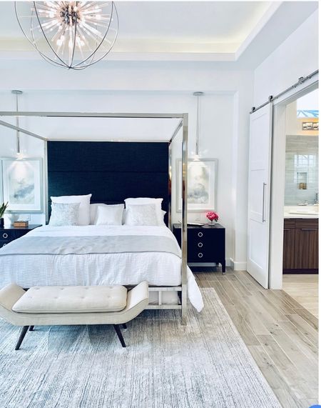 Contemporary Bedroom Design with 4 poster bed with black upholstery, storage bench, modern black nightstand and chandelier. #modernbedroomdesign 

#LTKhome