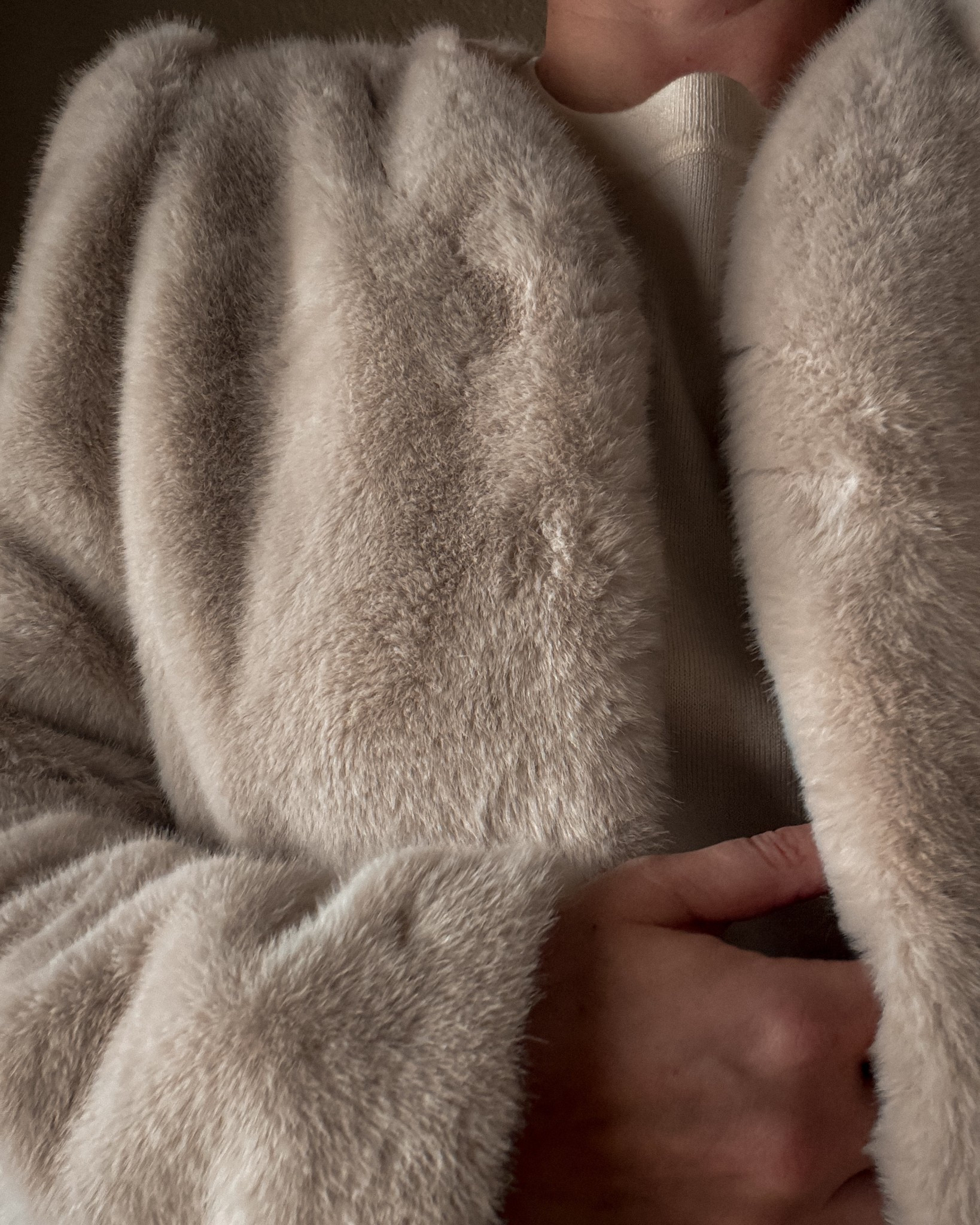 White collarless fur coat  
