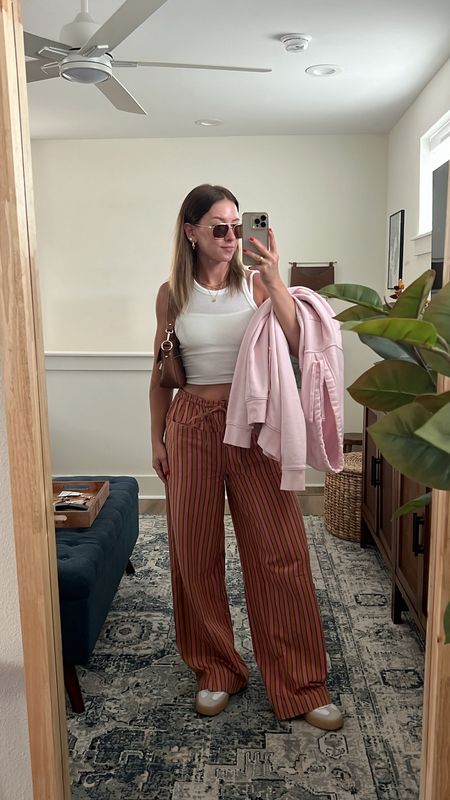 5/12/24 casual dinner & a movie outfit 🫶🏼 striped linen pants, free people style, free people pants, linen pants, summer fashion trends, basic tank, pink hoodie, adidas Sambae sneakers 