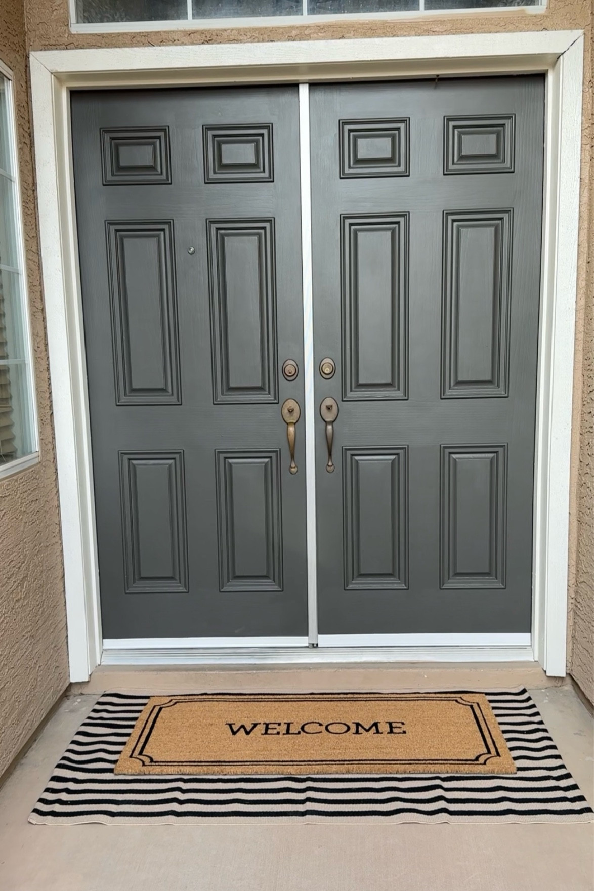 Front door refresh!!! No more bright green door. A fresh coat of paint does wonders 😍 
Paint - Urban Bronze by Sherwin Williams 
•••
Front door, front door styling, front porch, door mat, layered door mat, striped door mat, welcome mat 

#LTKHome #LTKFindsUnder50