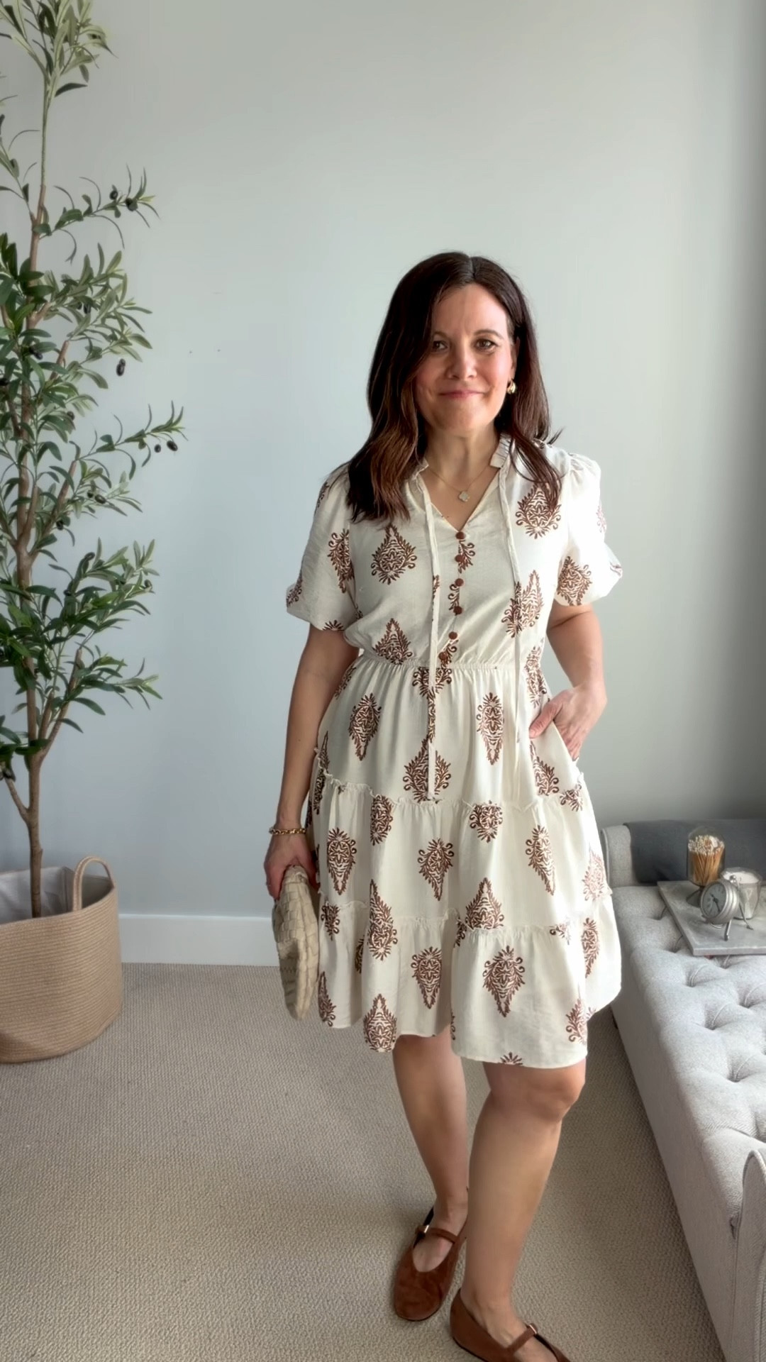 This cream dress with a brown block print is so charming. It has a short A-line tiered skirt with a thin elastic waistband, a tie ruffle notch neckline with non-functional buttons, and short puff sleeves that add a little shape up top.
The fabric is soft and comfortable, which makes it easy to wear all day. It’s lined, has pockets, and the length works perfectly at 5’6”. I chose a small based on the bust size in the sizing chart and it fits true to the sizing chart. 


#LTKOver40 #LTKMidsize #LTKSeasonal