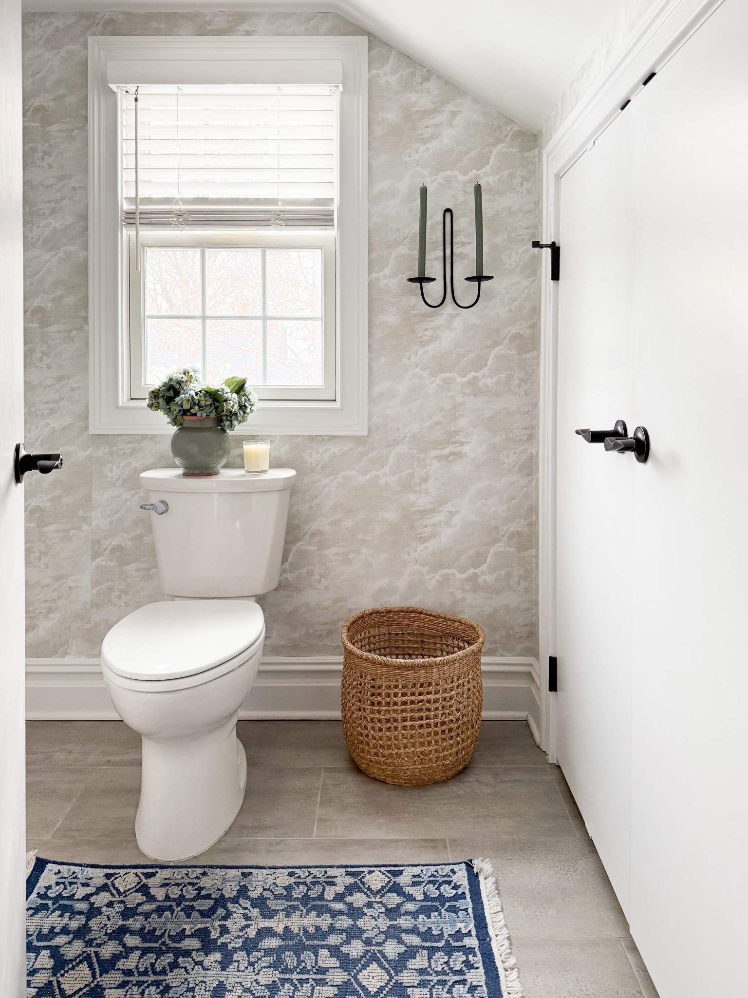 This full view ties everything together so beautifully, from the soft, cloud like wallpaper to the layered mix of warm and cool tones. The woven basket and blue runner add just enough contrast to ground the space while still keeping it light and airy. A perfect example of how thoughtful styling can make even a small attic bathroom feel elevated and complete.

neutral bathroom decor, small bathroom inspiration, bathroom wallpaper ideas, attic remodel, blue runner rug, woven basket decor, cottage style bathroom, light and airy interiors, bathroom styling ideas, cozy neutral home, elevated everyday spaces girlonthehudson

#LTKSeasonal #LTKHome #LTKdayinmylife