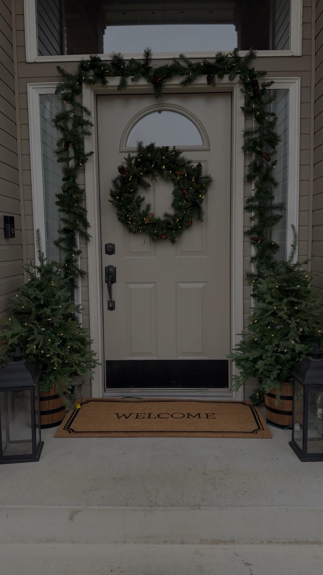 Front door holiday decor! I used 2 9’ garlands for my door frame. The wreath and garland have an option for multi color lights too! Wreath, exterior garland, porch decor , door mat 