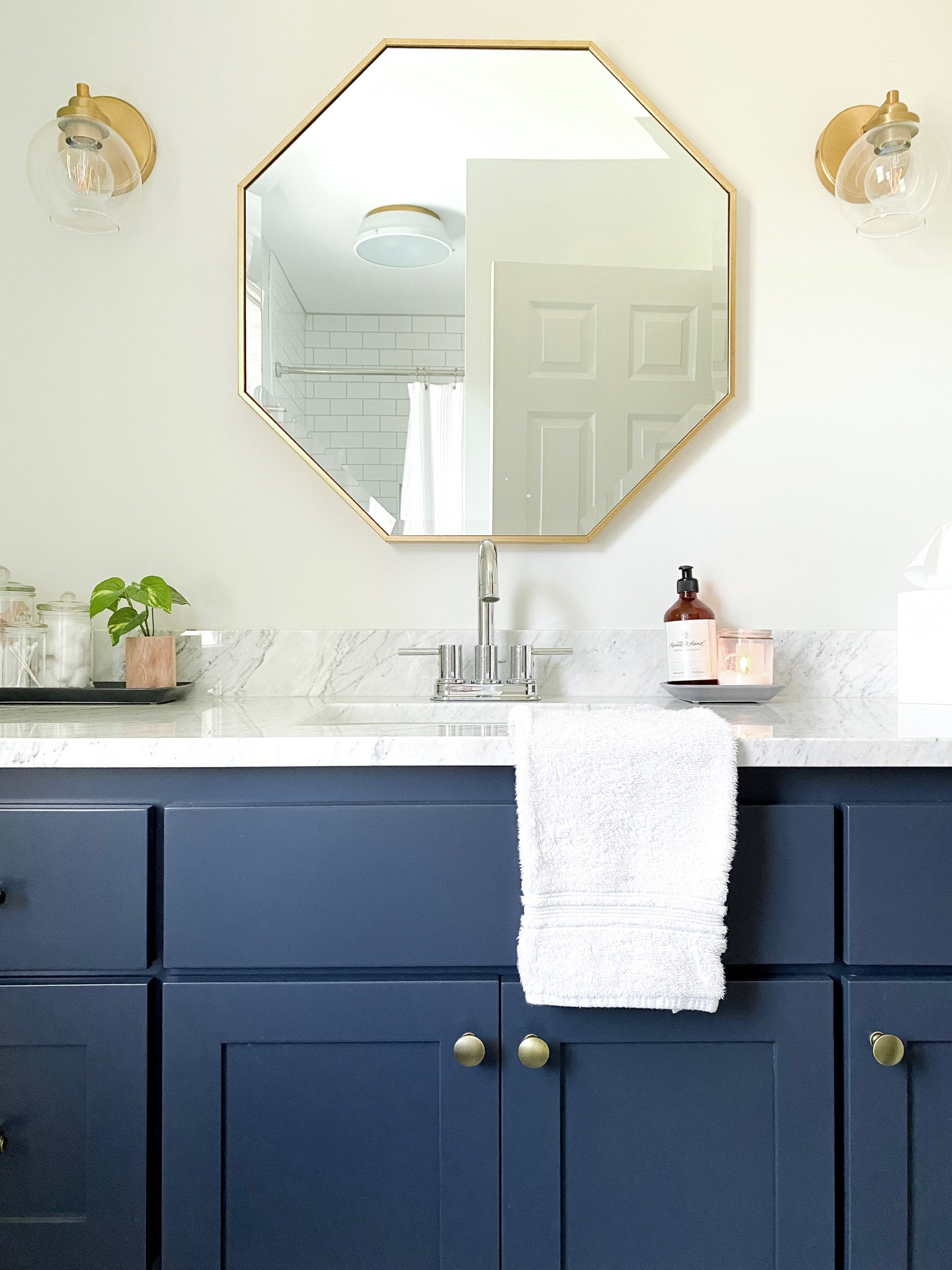Bathroom with gold hardware and fixtures blue vanity marble counters chrome faucet

#LTKfamily #LTKhome #LTKstyletip