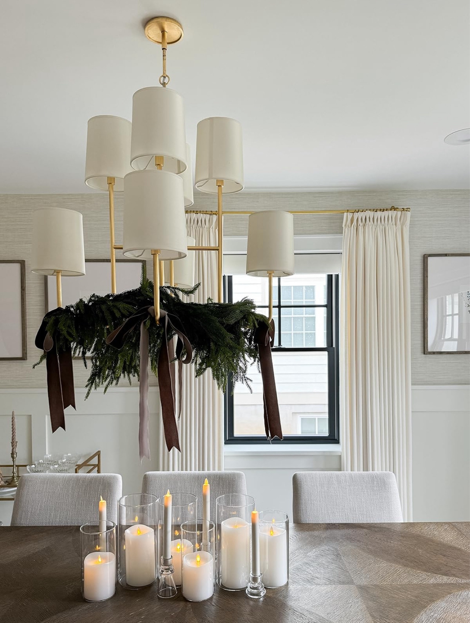 I used two strands of Norfolk, pine garland around my gold shaded chandelier and added these chocolate velvet ribbons. I love how this brings the eye up and leaves plenty of room on the table. I did a simple centerpiece of flickering Luminara candles in glass, tapered, candleholders, and hurricanes from Amazon! This is such a beautiful understated and affordable dining room decorating idea perfect for Thanksgiving, and Christmas.

#LTKHome #LTKStyleTip #LTKHoliday