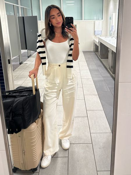 Comfy chic travel outfit ✈️ size 4 pants (could have done a 2 but I prefer more room in the waist), XS bodysuit (fits TTS), Small striped sweater 





Airport outfit, trousers outfit, striped sweater, casual outfit, travel duffle, carry on suitcase 

#LTKstyletip #LTKtravel #LTKunder100