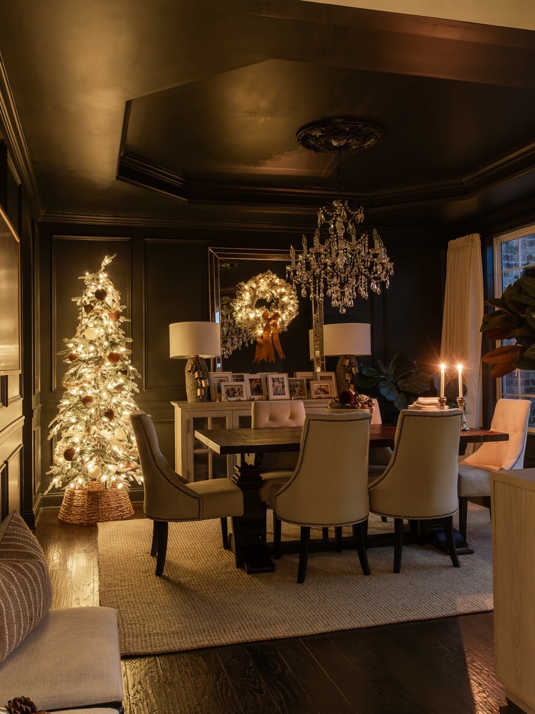 The magic of Christmas shines through at night with the lights turned down low with only the Christmas tree and wreath glowing in our moody dining room. home decor dining room decor flocked Christmas tree Iron Ore paint

#LTKHoliday #LTKHome #LTKSeasonal