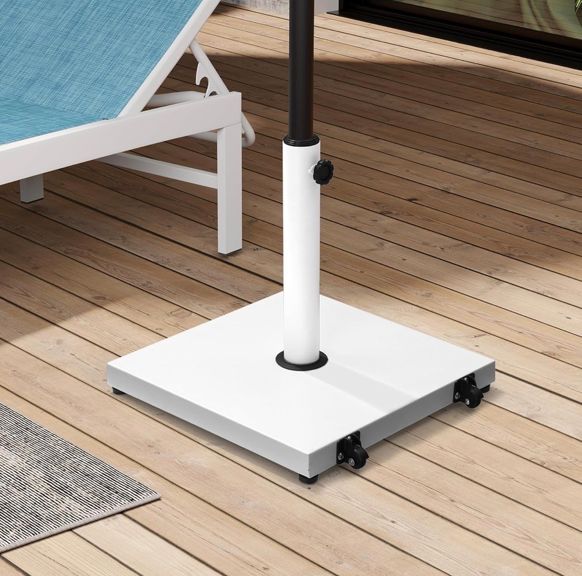 White umbrella stand on wheels. Easy for chasing the sun. Black wheel accents to add contrast.

#LTKSeasonal #LTKHome #LTKSwim
