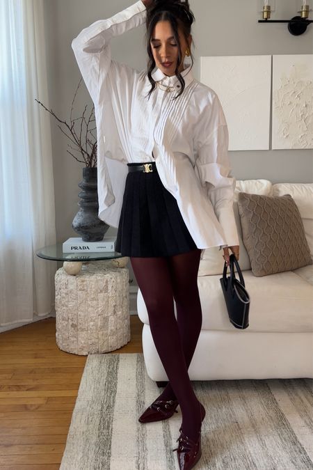 Button up shirt outfit, mini black skirt outfit, cherry red tights, burgundy tights, Miumiu shoes dupe

#LTKfindsunder100 #LTKstyletip