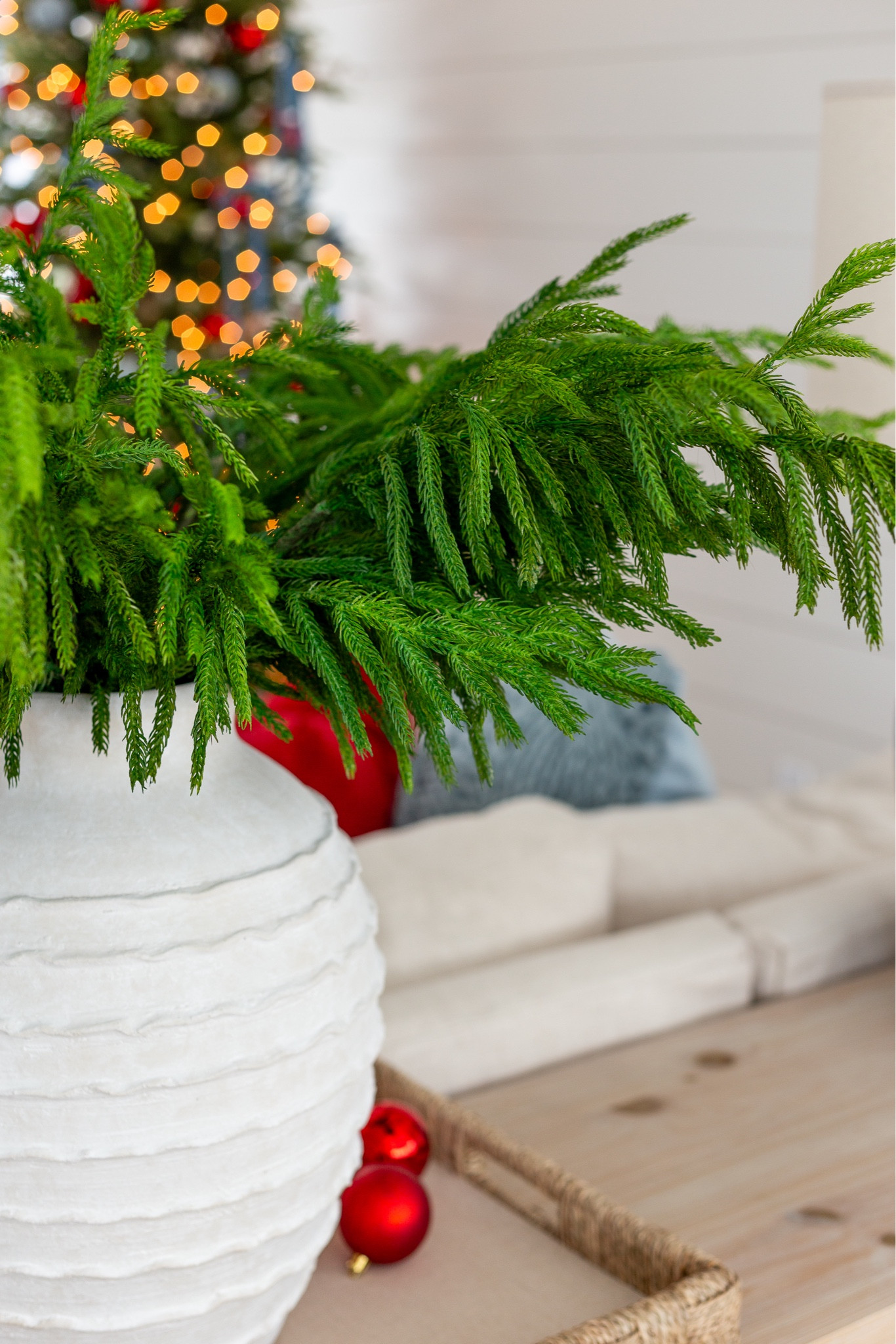 This is one of my favorite faux evergreen stems for the holidays! I'm using the Afloral version here (which is currently on sale), but I'll also link another option that is very similar. It's so pretty in this oversized white vase in our loft with picture ledge shelves, gray blue lamps, woven tray, light wood console table, linen sectional and O Holy Night canvas art. #ltkholiday #ltkhome #ltksalelaert #ltkfindsunder50 #ltkfindsunder100 #ltkseasonal #ltkstyletip 

#LTKHome #LTKHoliday #LTKSaleAlert