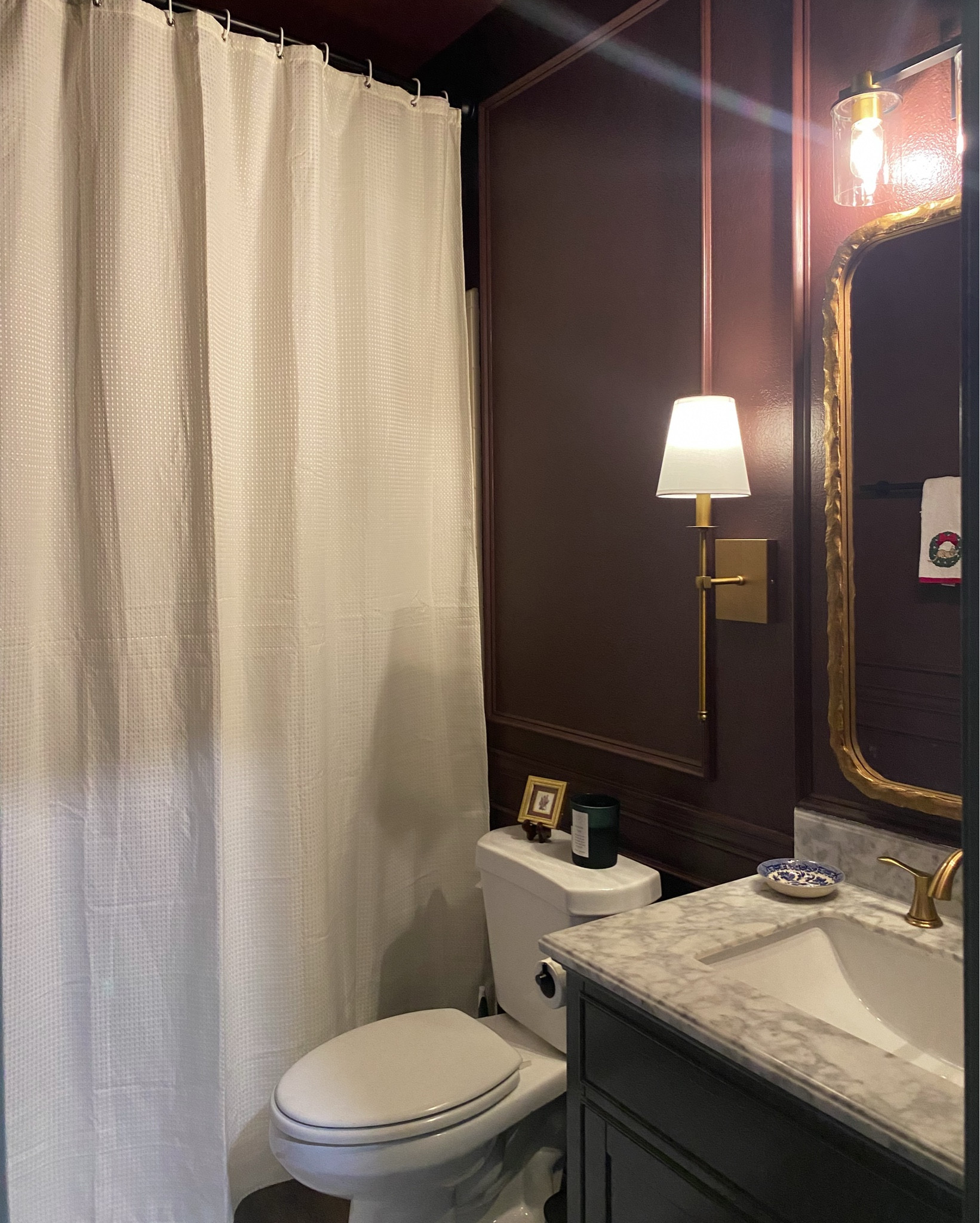 Our small guest bathroom makeover, we love it! The paint color is Carnelian by Sherwin-Williams. Raising the shower curtain, adding trim and painting all walls even the ceiling made the space feel taller!

#LTKHome #LTKStyleTip