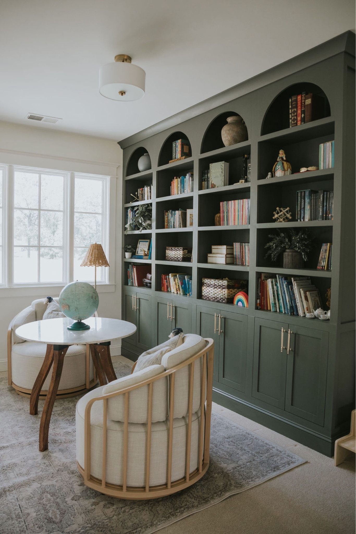 I love the statement these deep green arch bookshelves bring to this reading loft 💚 This is now an ideal place for the kids to come and grab a book and read, do homework, or play a game or puzzle on the table. 

#LTKHome
