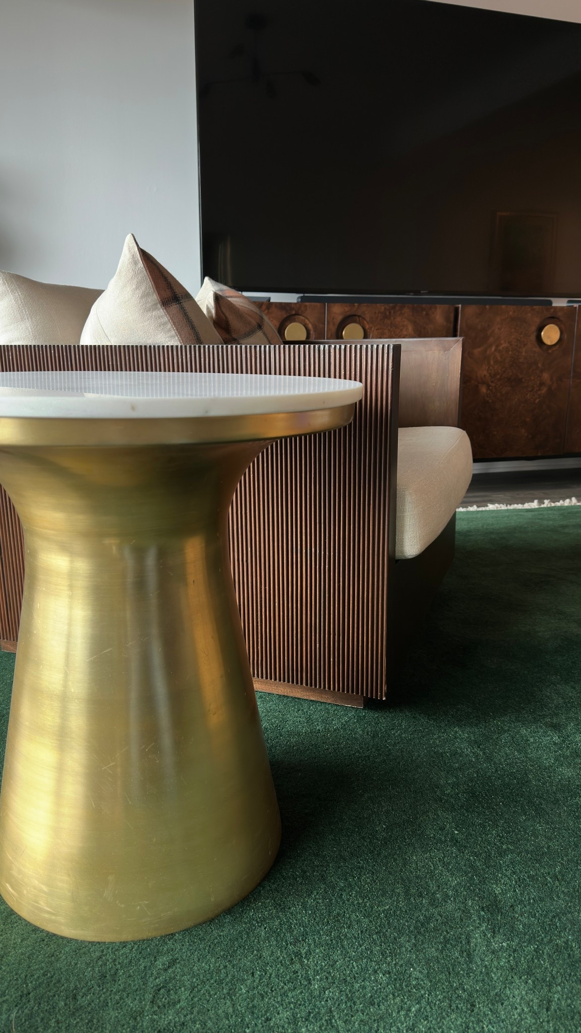 This marble and brass pedestal side table is such an eye catcher! In this living room, I paired with a bold green area rug, custom made swivel chairs, and a STUNNING burl wood media console table.

#LTKSaleAlert #LTKHome