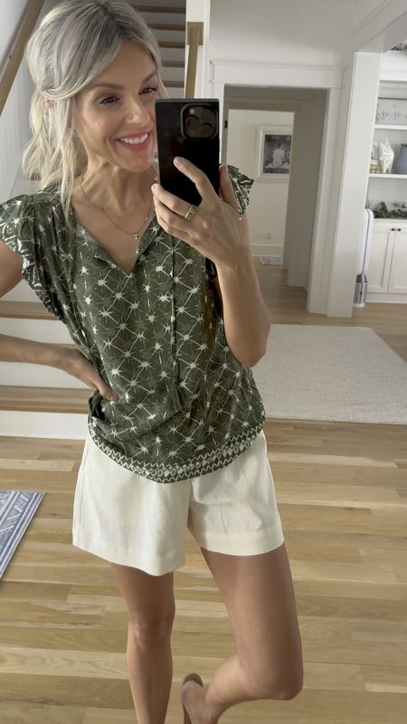How cute is this look! Don’t just look at the cover photo watch the video too! You can see the $13 green top tucked in and untouched, depending on how you prefer to wear it. It’s true to size and the perfect lightweight flowy top for summer.

And then my shorts are only $20. I have them in this white color and then also in the beautiful floral print that is still available and most sizes. 