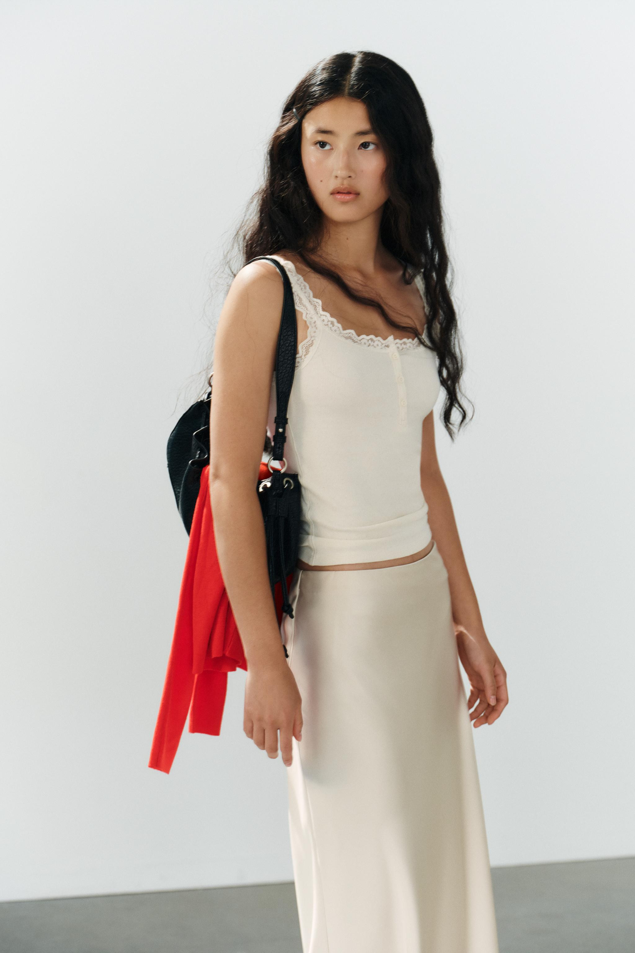 High-waisted midi skirt made of satin effect fabric with an elastic waistband. | Zara US