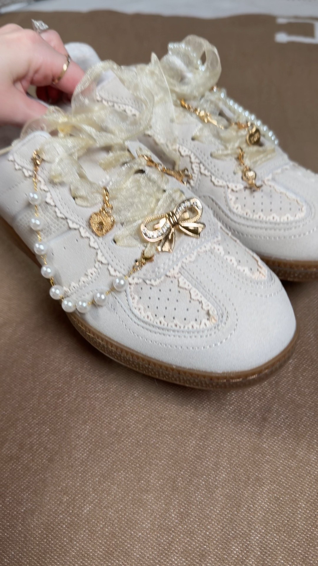 Personalizing the cutest lace ribbon sneakers 😍 these are the perfect shoes to add fun shoes charms and chains to, especially pearls
