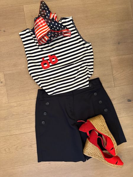 Navy Sailer shorts. Navy and white stripe tank, red wedge sandals, espadrilles 
Red statement earrings, square Stars and Stripes scarf, Memorial Day outfit, 4th of July outfit. 

#LTKOver40 #LTKFindsUnder100 #LTKSeasonal