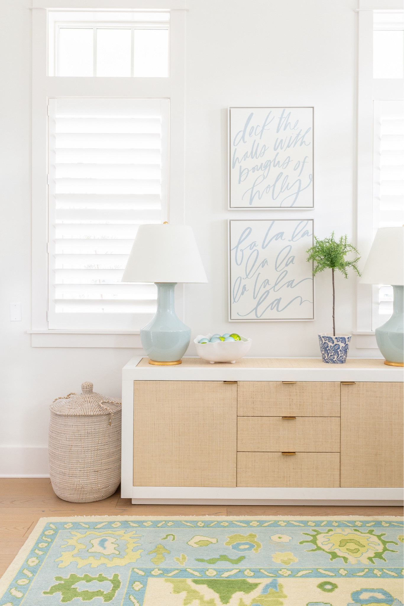 One of my favorite Christmas decor views from last year was this angle from my desk in my office! The Christmas art (mine are 20x24 in the white gallery frame), rattan cabinet, colorful oushak rug,  and sea glass blue lamps are all faves. I added this bowl of blue and green ornaments for a festive touch. See our full coastal Christmas home tour here: https://lifeonvirginiastreet.com/2023-coastal-christmas-home-tour/.
.
#ltkhome #ltksalealert #ltkfindsunder50 #ltkfindsunder100 #ltkstyletip #ltkholiday #ltkover40 #ltkseasonal

#LTKHoliday #LTKSaleAlert #LTKHome