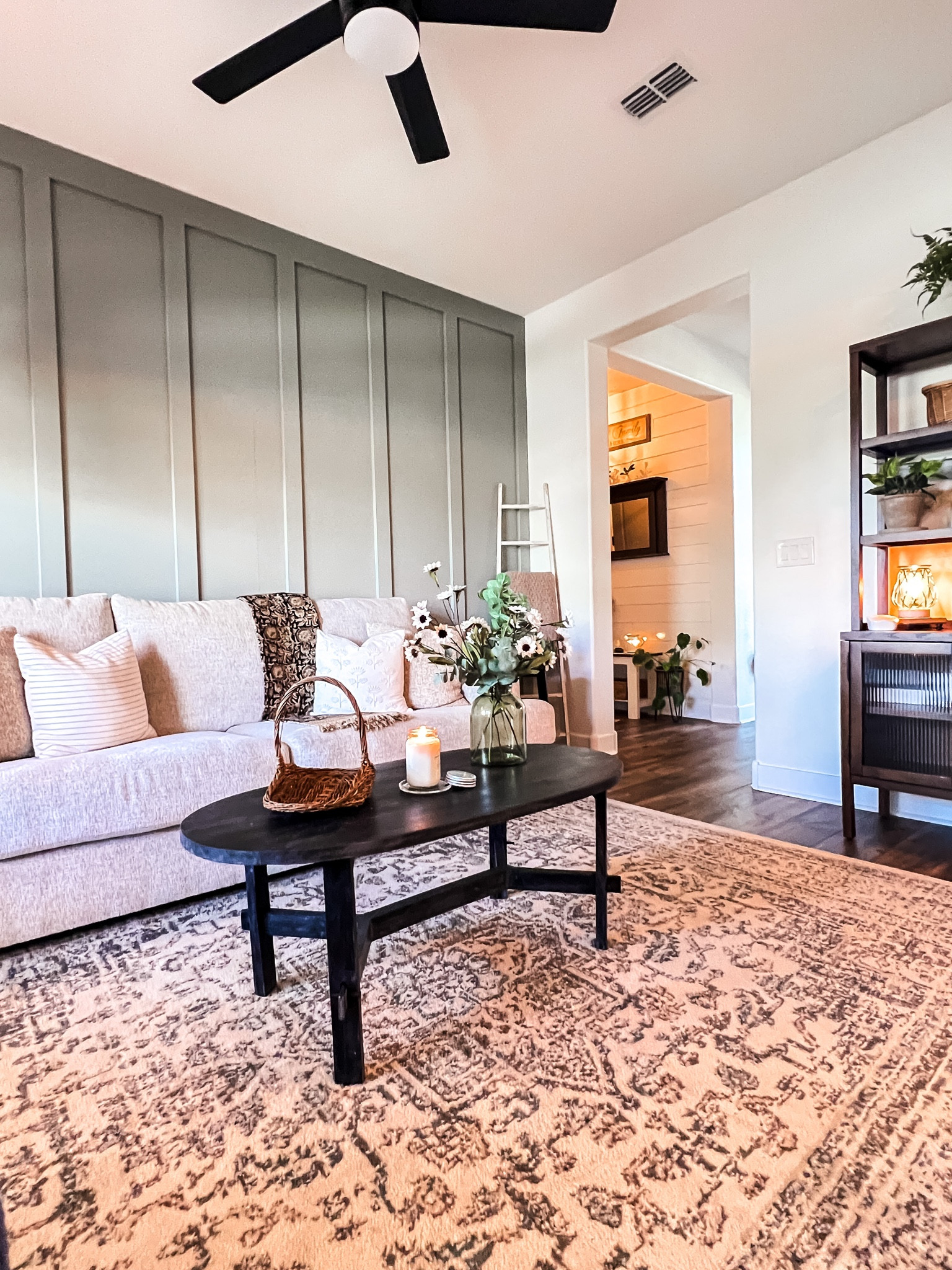 Neutral living room, vintage style, Addy Black oval coffee table, vintage style area rug, Wayfair rug, Target furniture, bakers rack, open shelving cabinet. 

#LTKhome #LTKunder100 #LTKstyletip