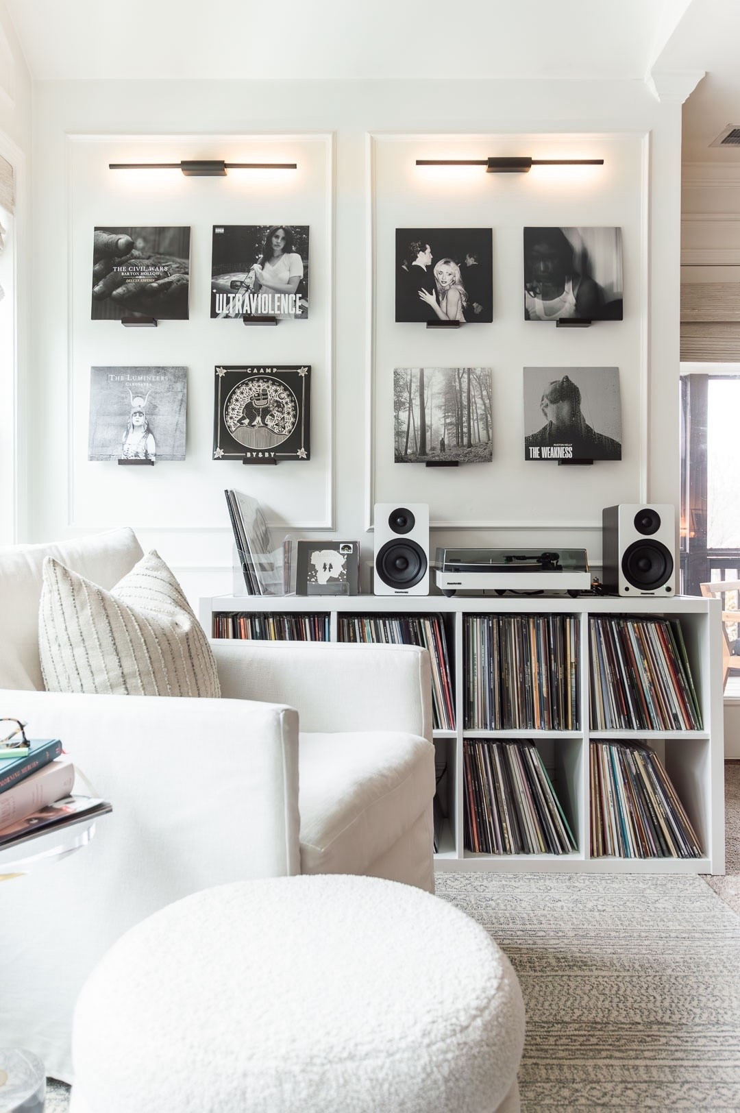 I’ve created a reading and listening nook in this little corner of my bedroom and I love showcasing a vinyl theme for the month on these floating wooden shelves, topped with rechargeable sconces. home decor record collection primary bedroom decor vinyl storage boucle storage ottoman neutral bedroom

#LTKOver40 #LTKselfcare #LTKHome